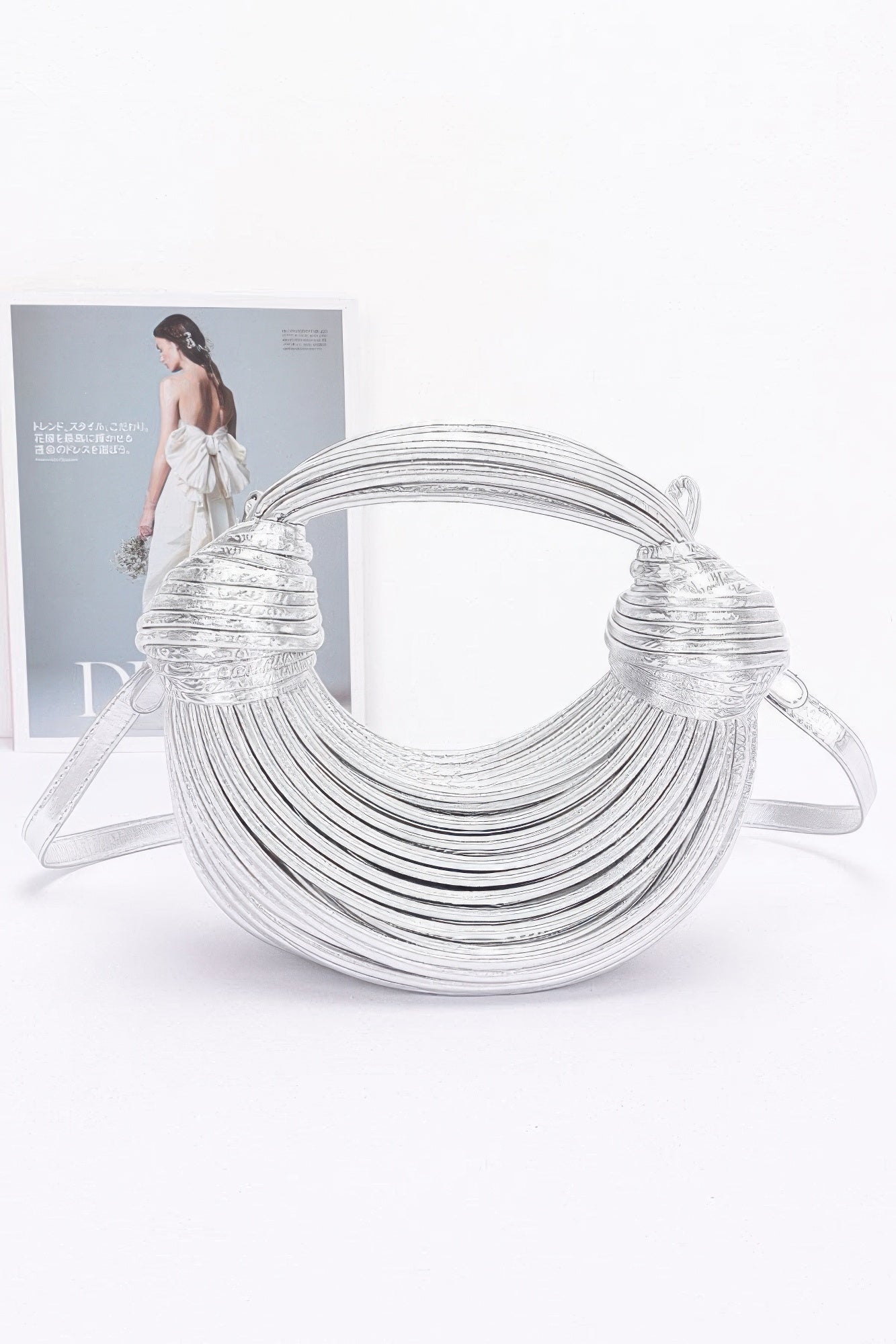 Silver faux leather rope hobo bag with multi-strand rope design and knotted handle caps
