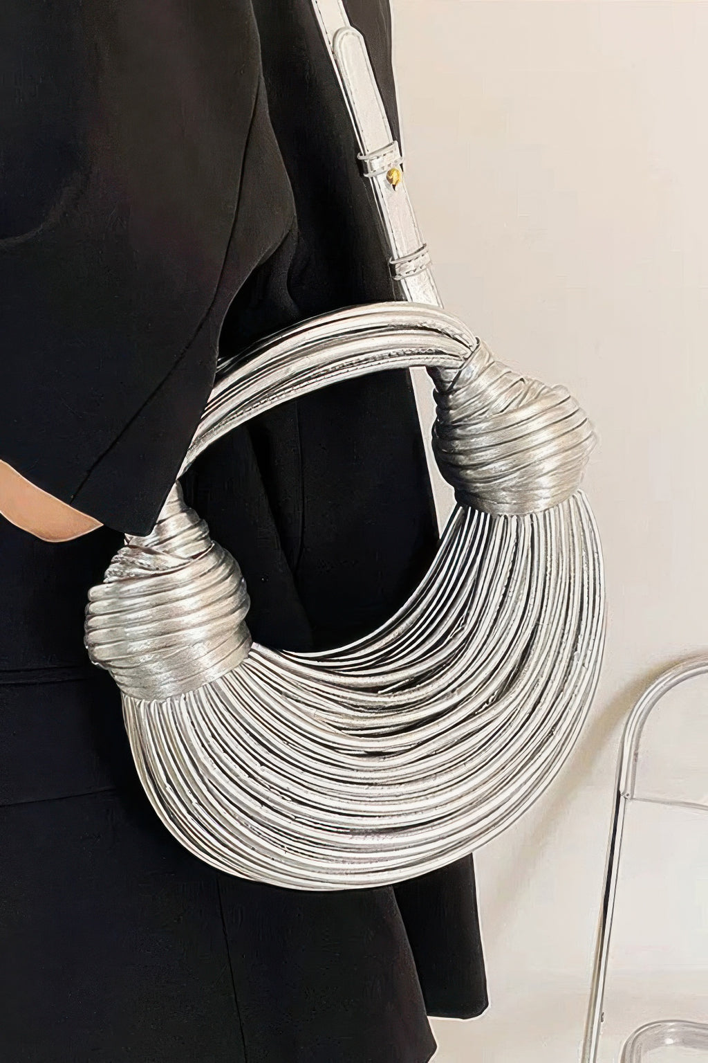 Silver faux leather rope hobo bag detail view with rounded rope layers and short straps