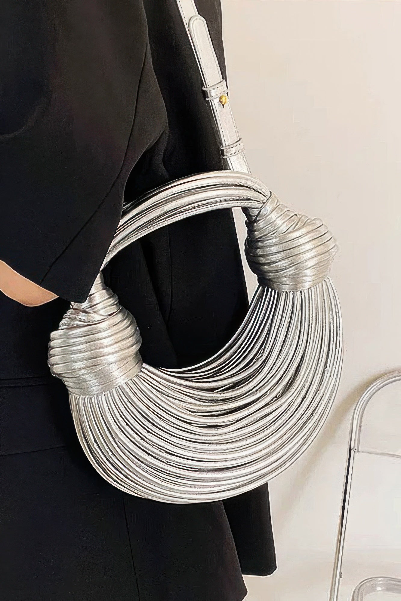 Silver faux leather rope hobo bag detail view with rounded rope layers and short straps