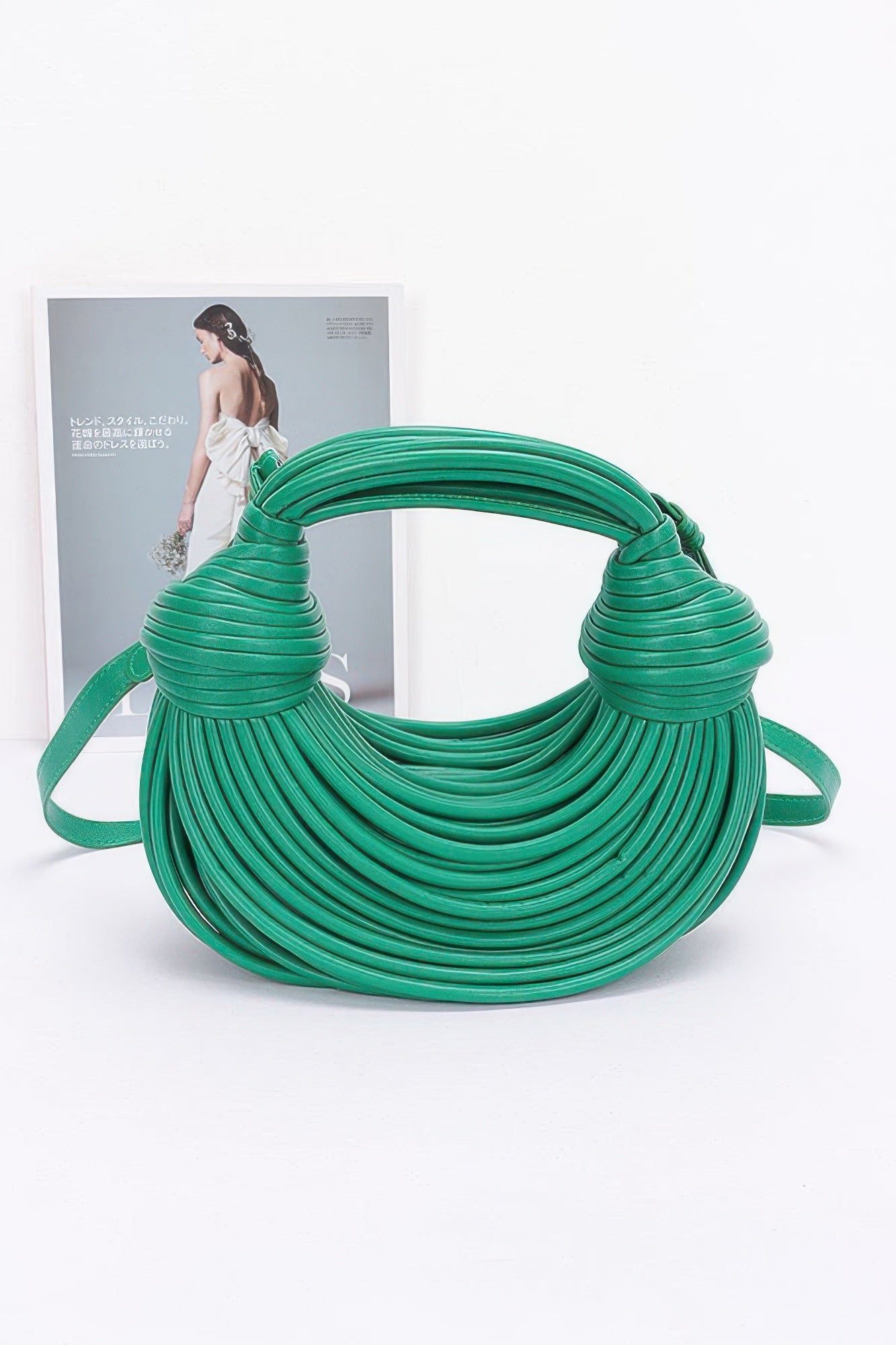 Green faux leather rope hobo bag with looped rope body and knotted shoulder handle ends