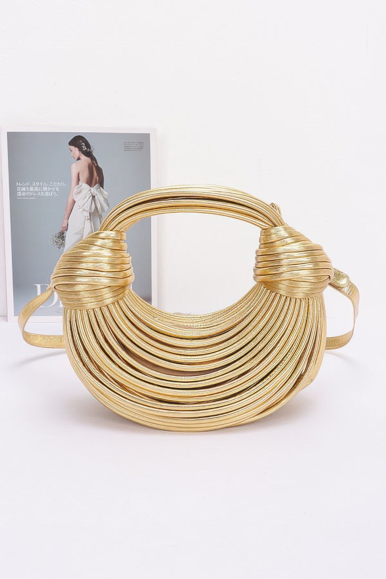 Gold faux leather rope hobo bag with layered braided rope body and knotted handle details