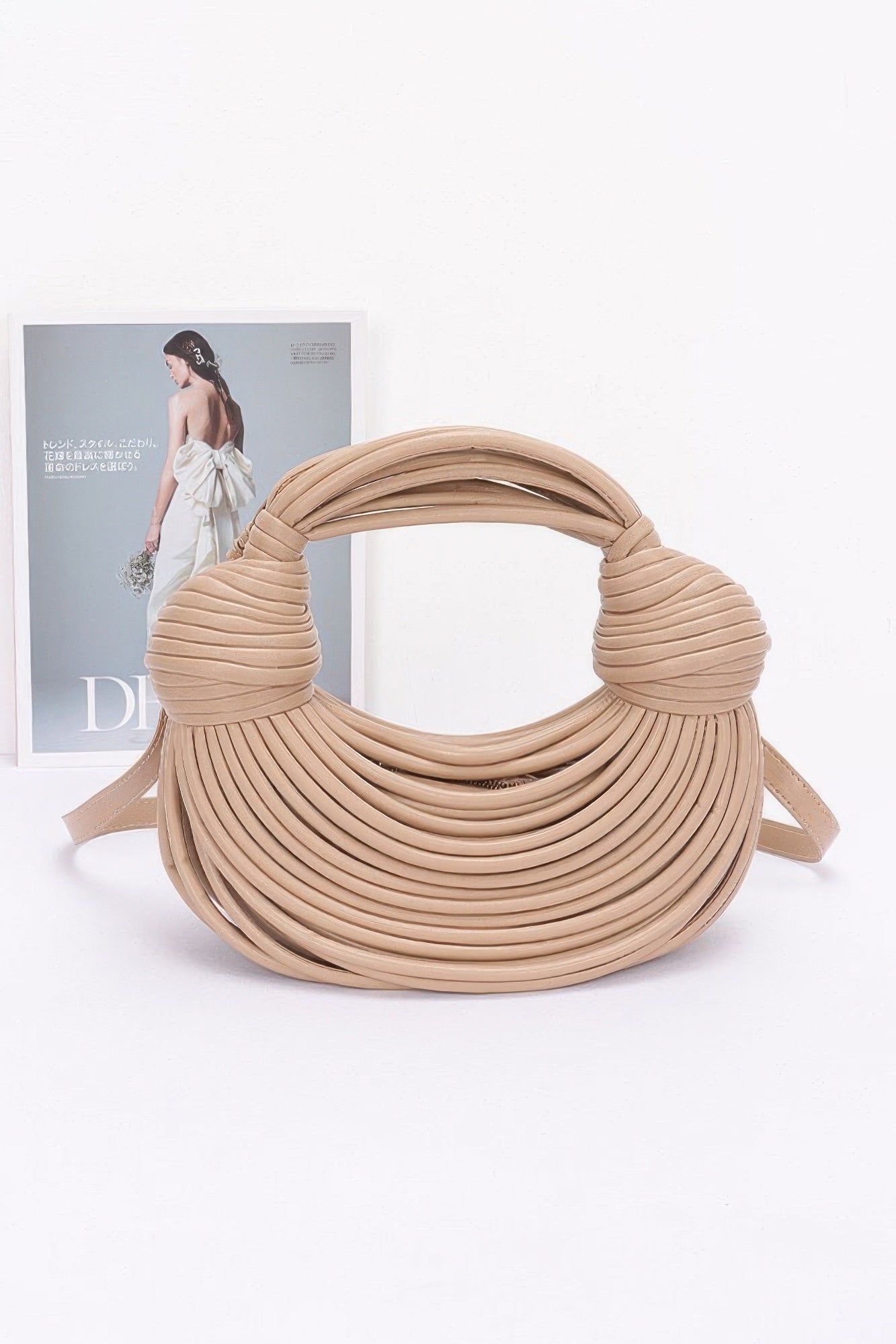Beige faux leather rope hobo bag with wide tubular handle and shoulder strap