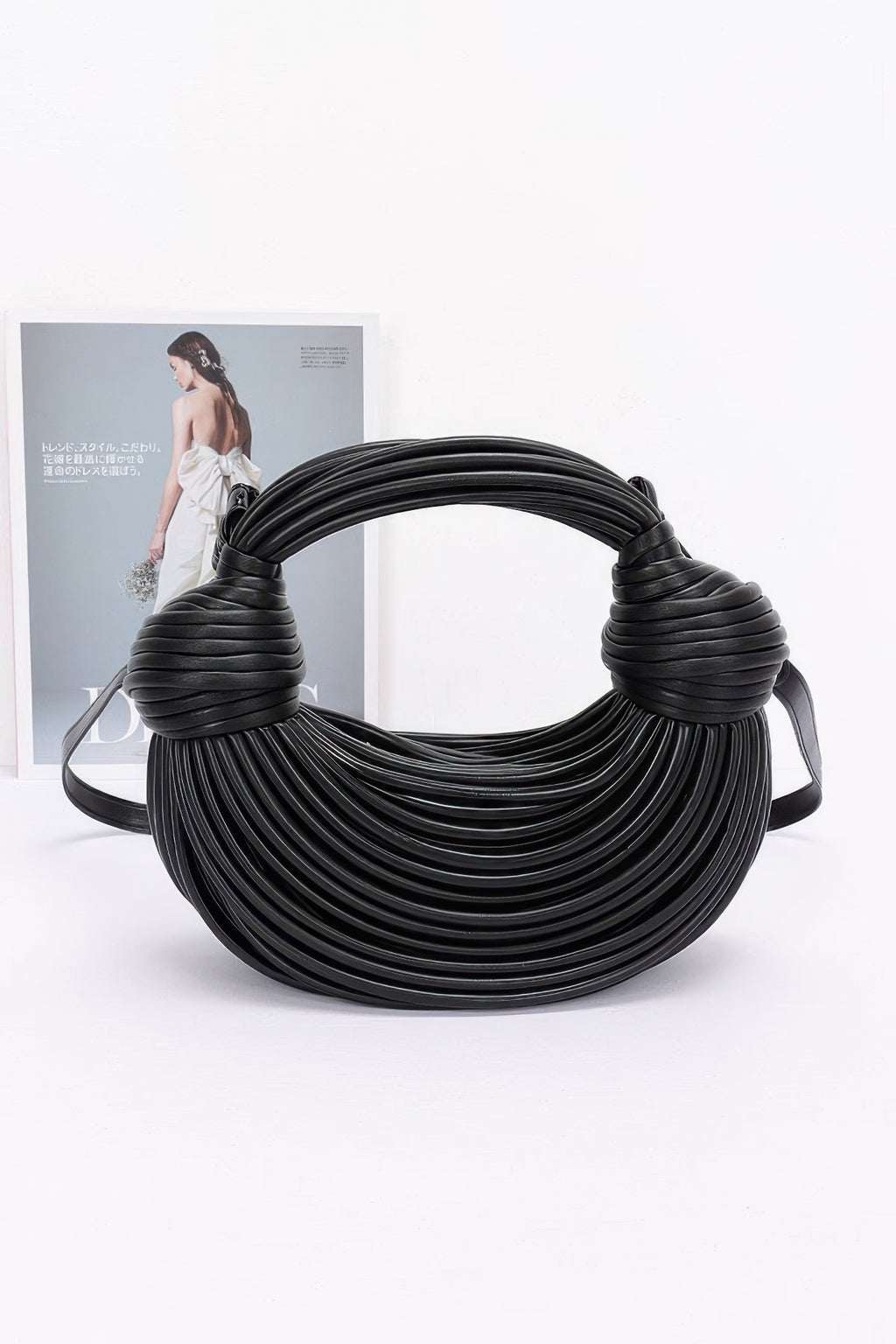 Black faux leather rope hobo bag with layered rope texture and shoulder strap