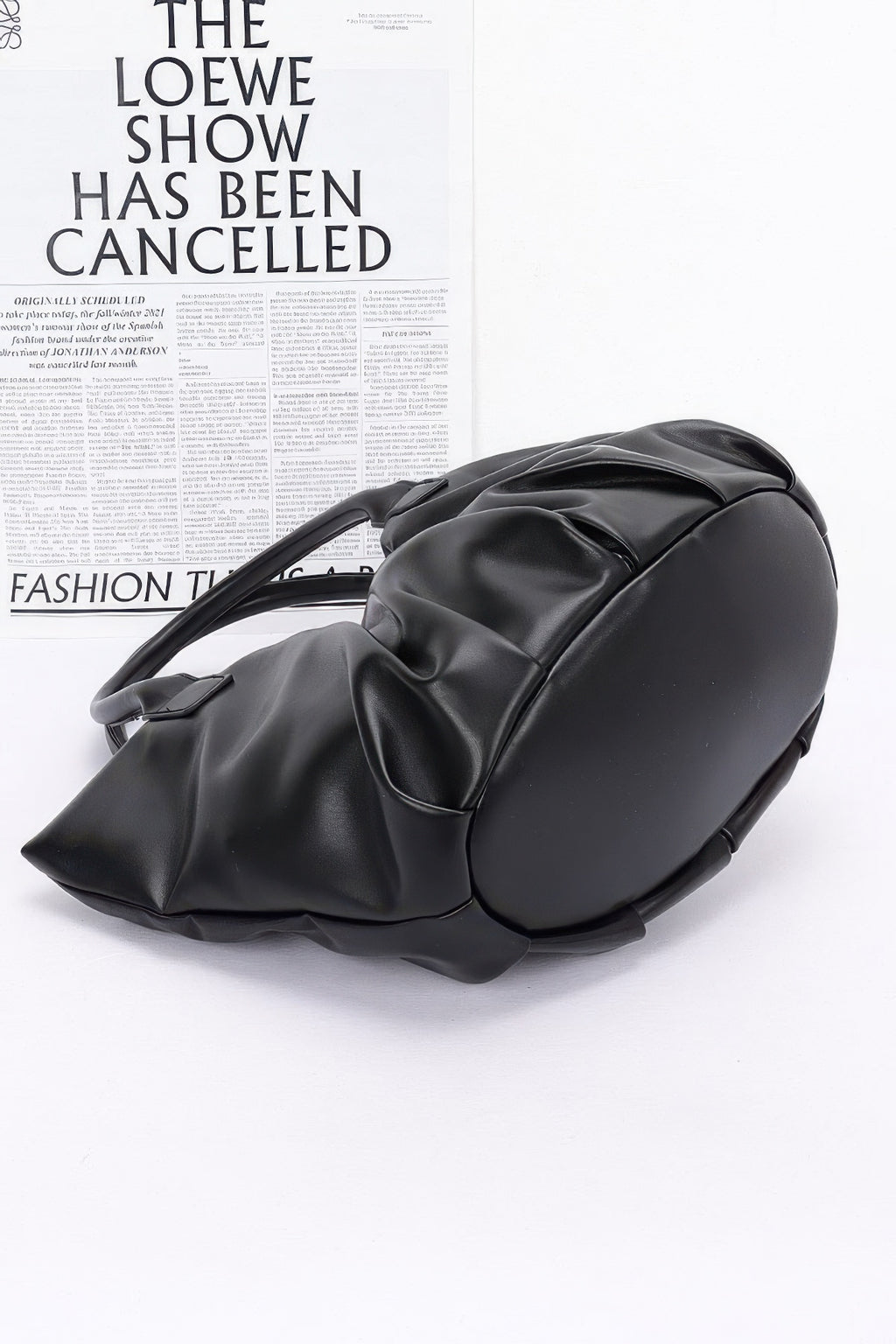 Faux Leather Tote Bag in black, side view with structured handles and gathered base