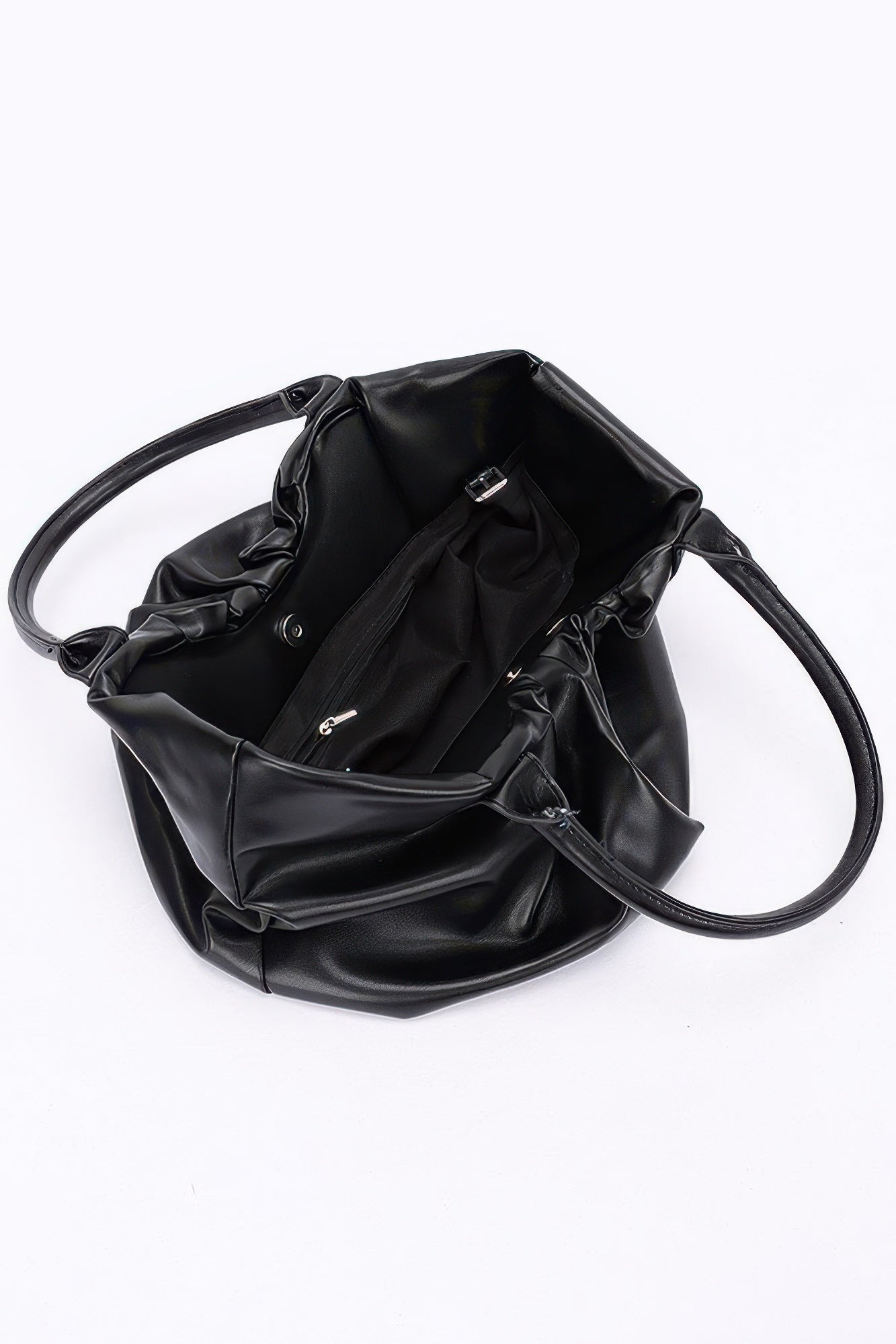 Black faux leather tote bag, open interior with pocket panel and crossbody strap