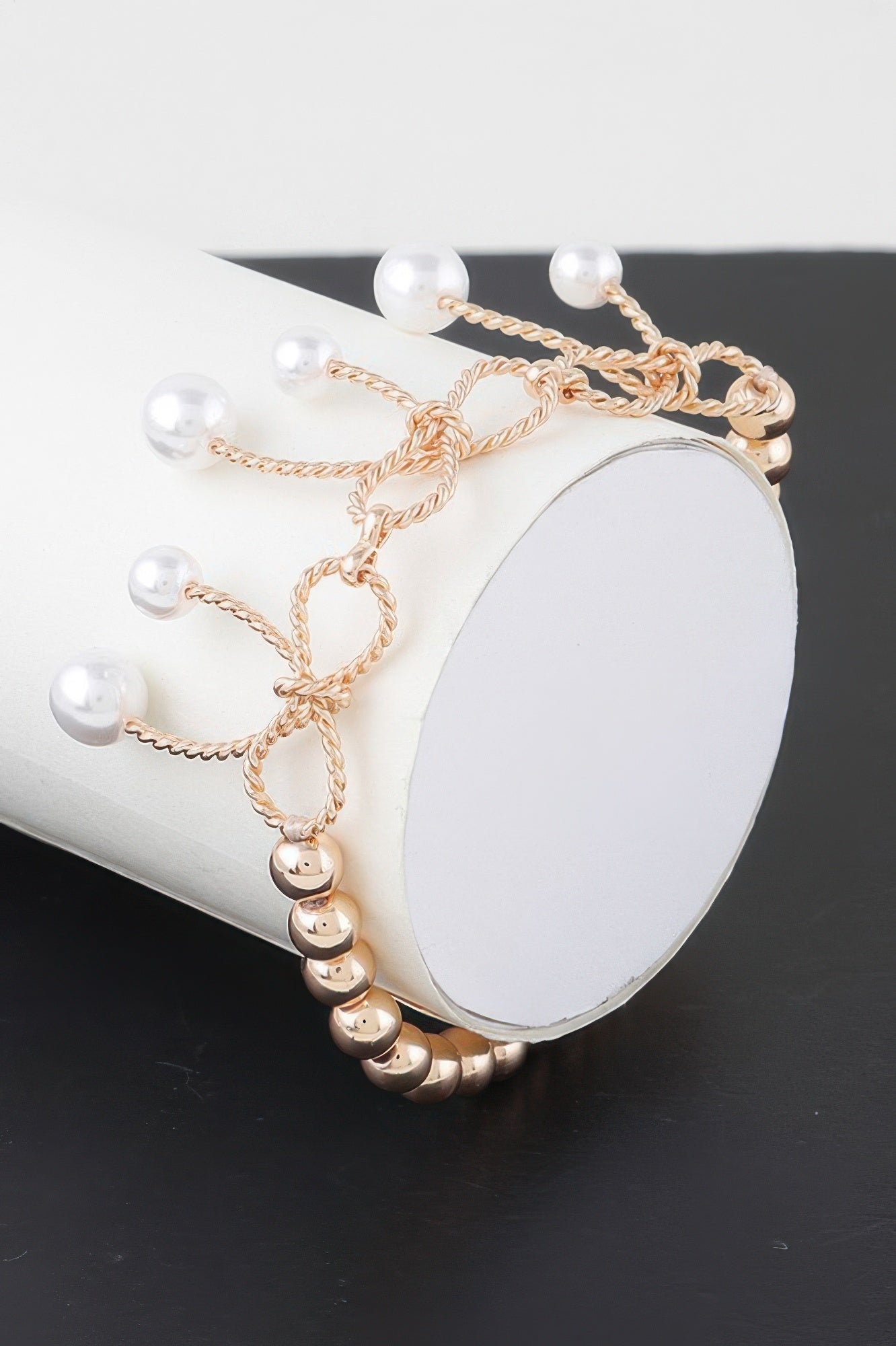 Gold faux pearl bracelet with dangling white pearls and braided links