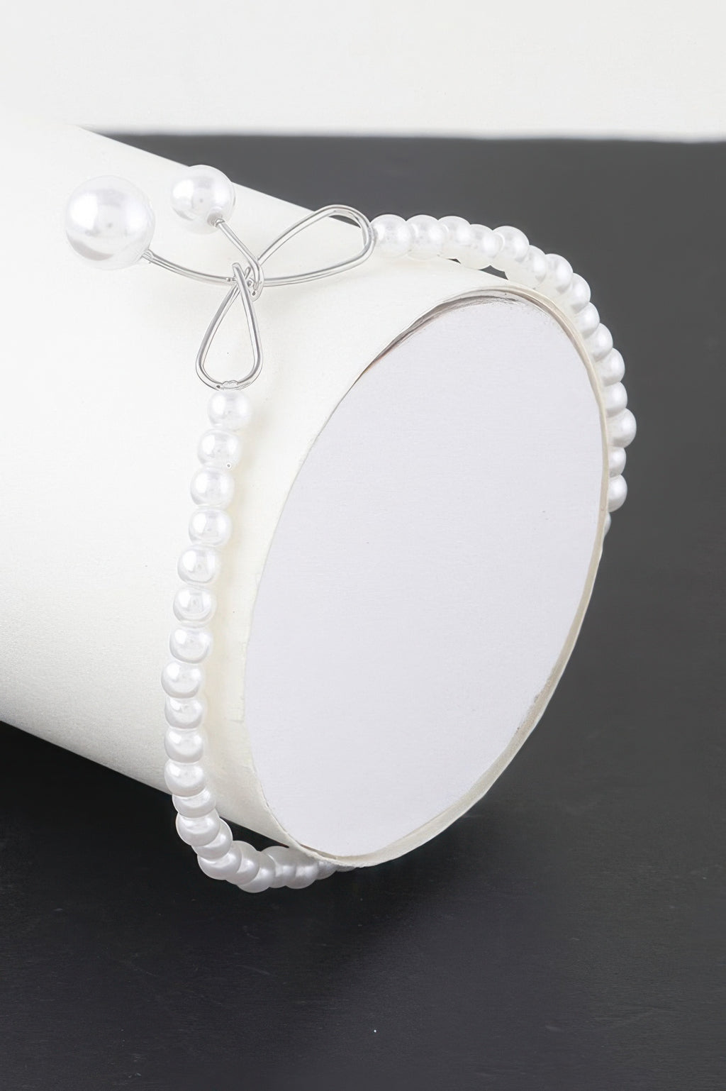 Faux pearl bow bracelet with silver-tone bow clasp and pearl bead frame