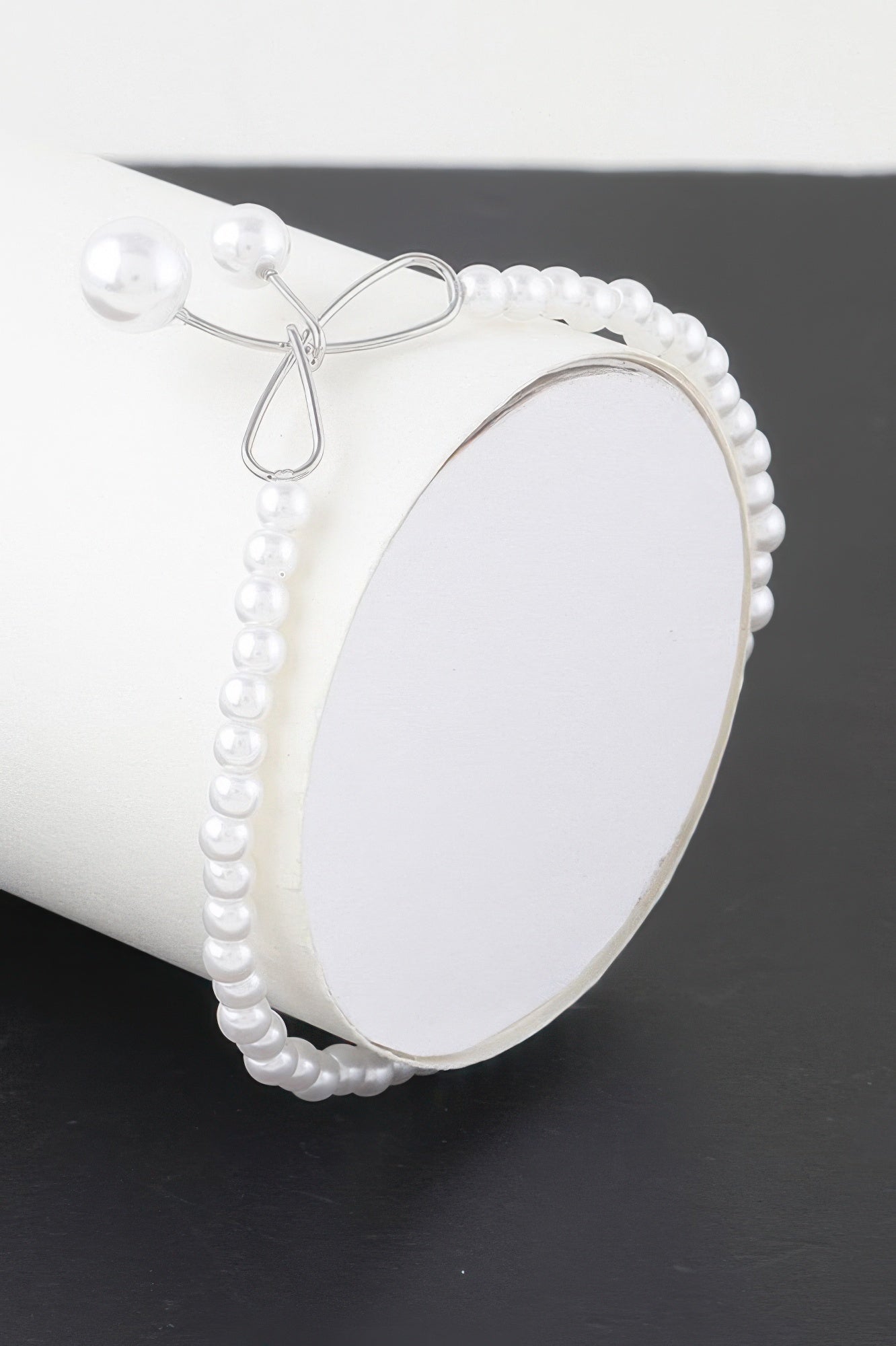 Faux pearl bow bracelet with silver-tone bow clasp and pearl bead frame