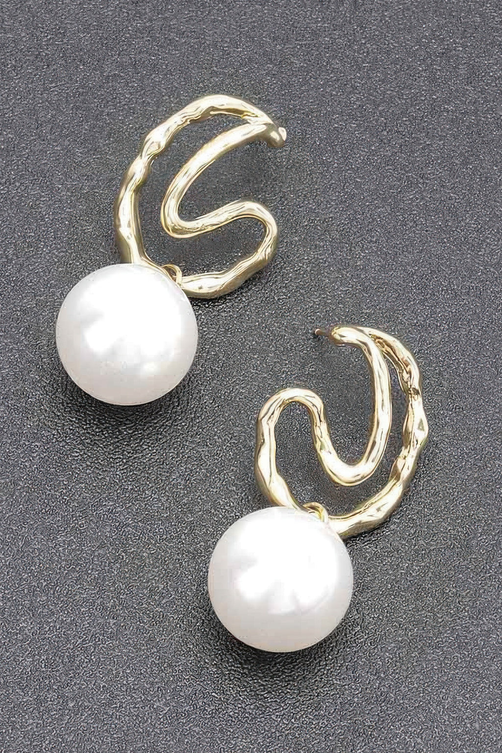 Gold-tone hoop earrings with faux pearl drops, close-up view