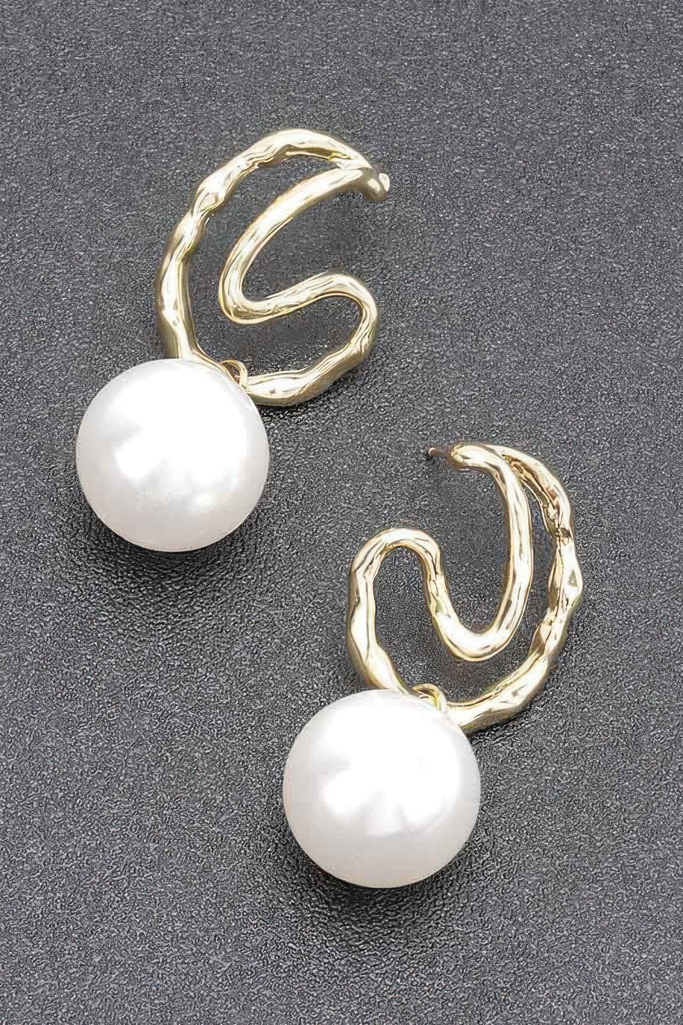 Gold-tone hoop earrings with faux pearl drops, close-up view