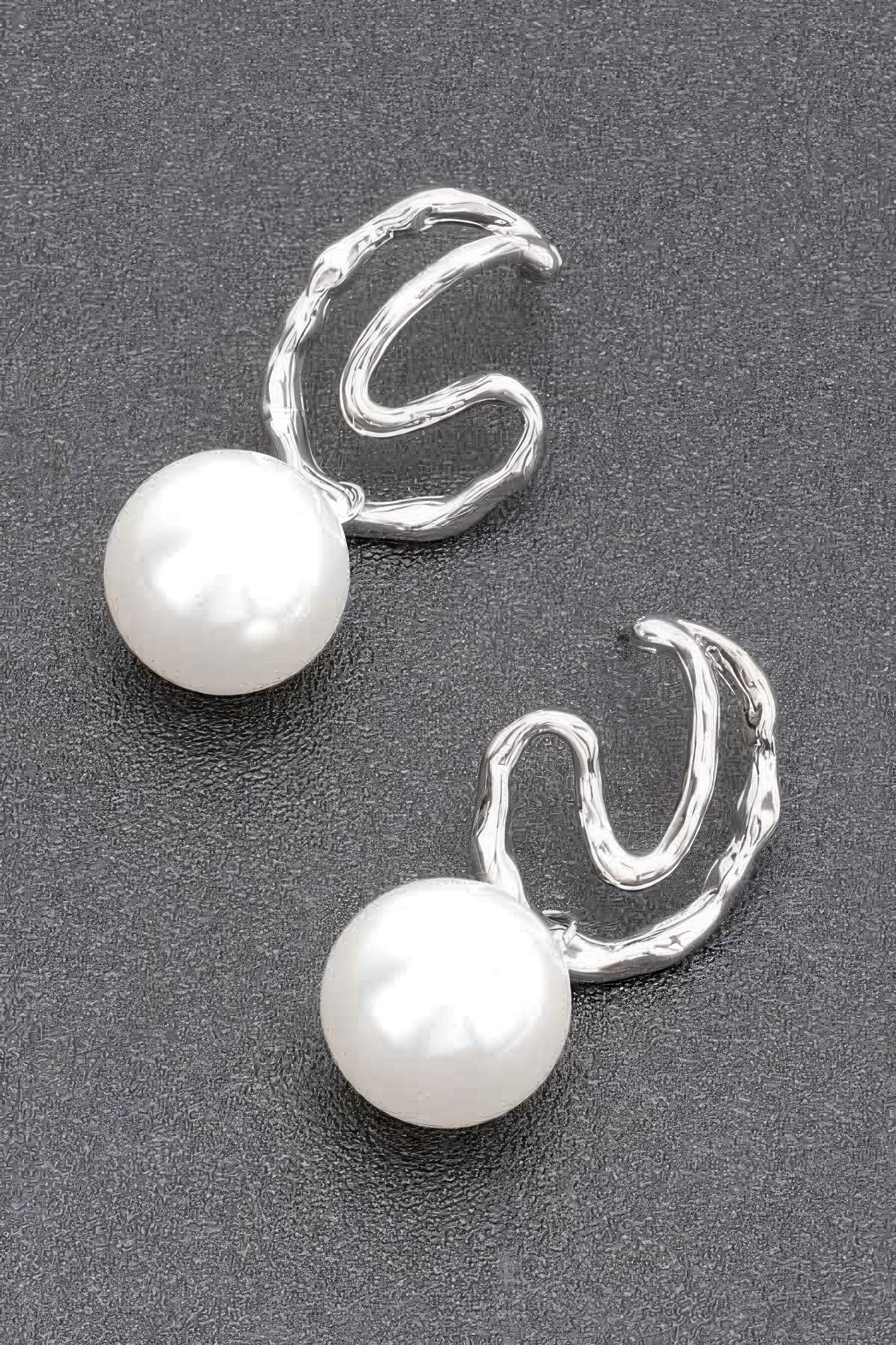 Silver faux pearl earrings with large pearl drops and curved twisted hoops