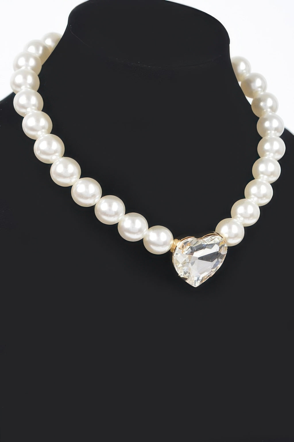 Cream faux pearl necklace with large faceted heart centerpiece at the front