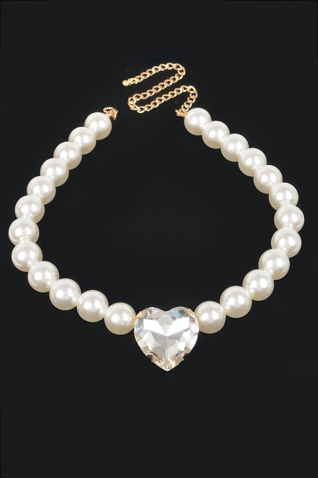 Faux pearl heart pendant necklace with gold-tone chain links and cream pearls