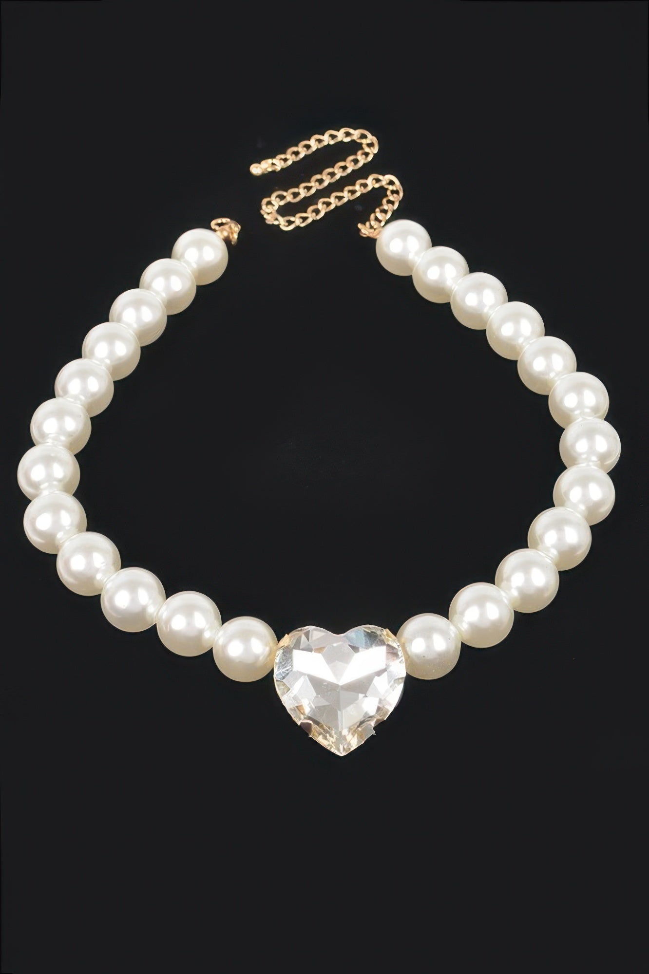 Faux pearl heart pendant necklace with gold-tone chain links and cream pearls