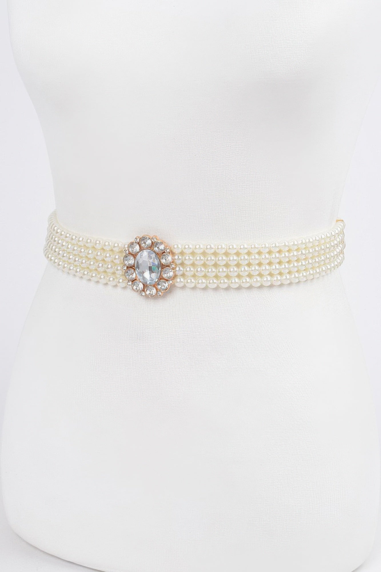 Ivory faux pearl stretch belt, front view with round rhinestone centerpiece