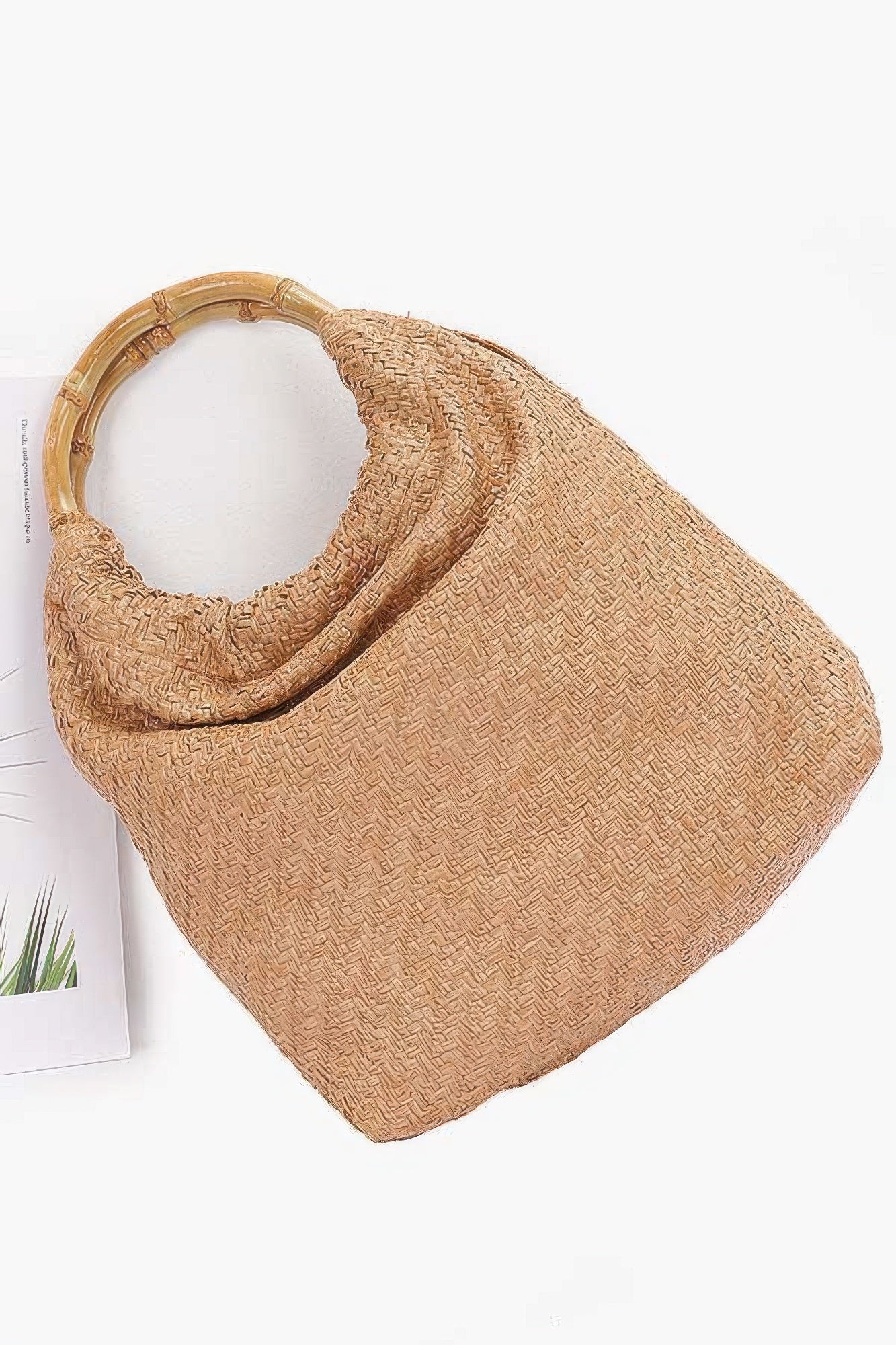 Camel faux straw handbag with bamboo handle, angled view
