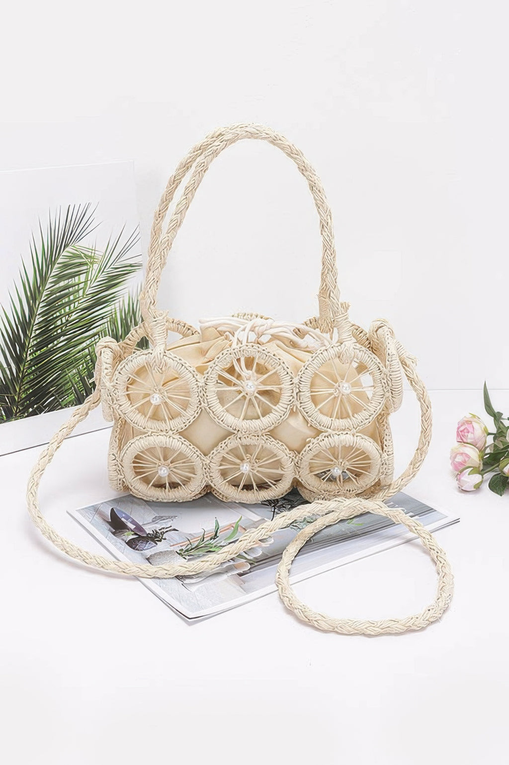 Ivory faux straw round crossbody bag with braided handle and wheel bead appliqués