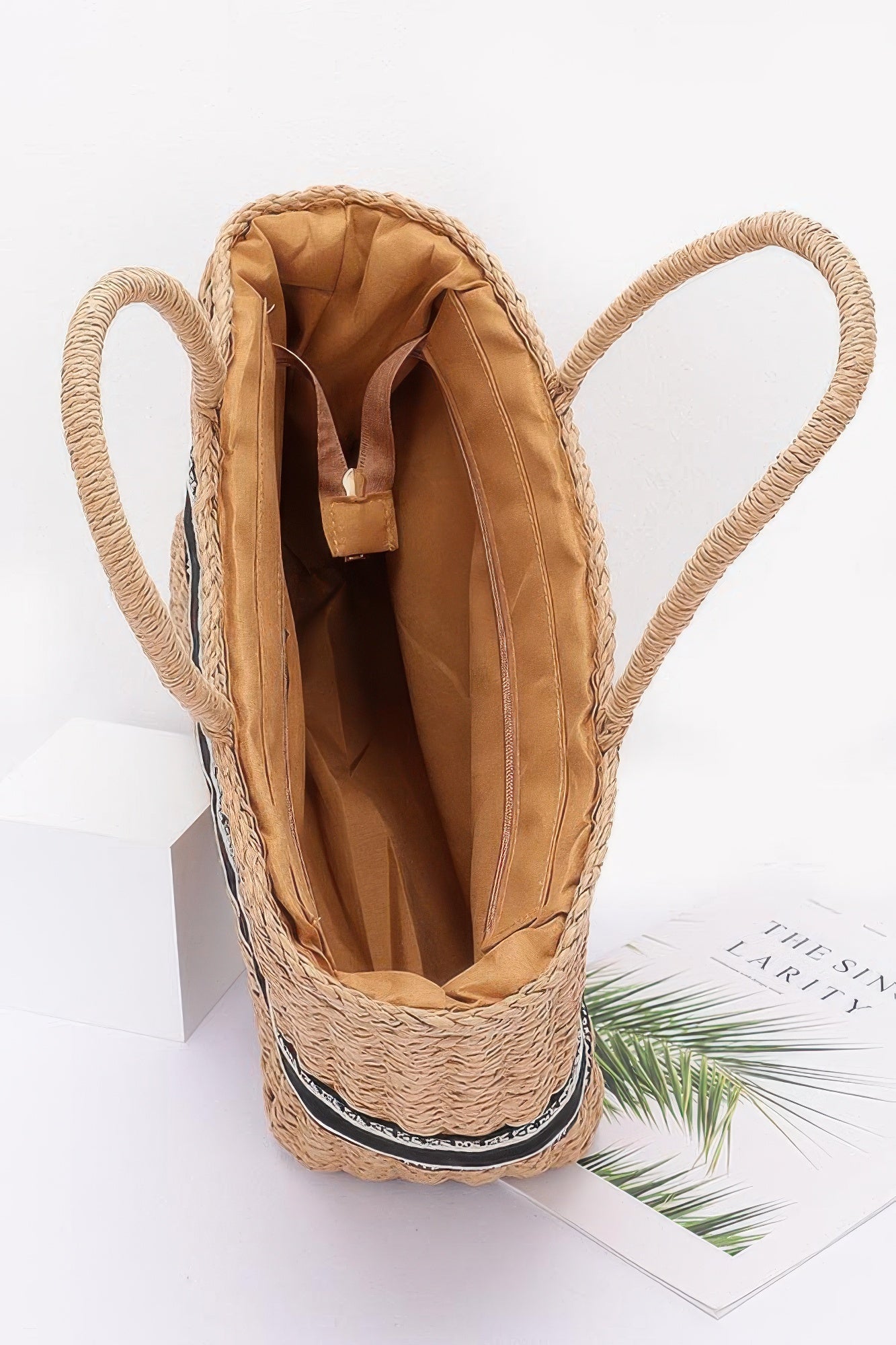 Khaki faux straw tote bag interior with tan lining and rope handles