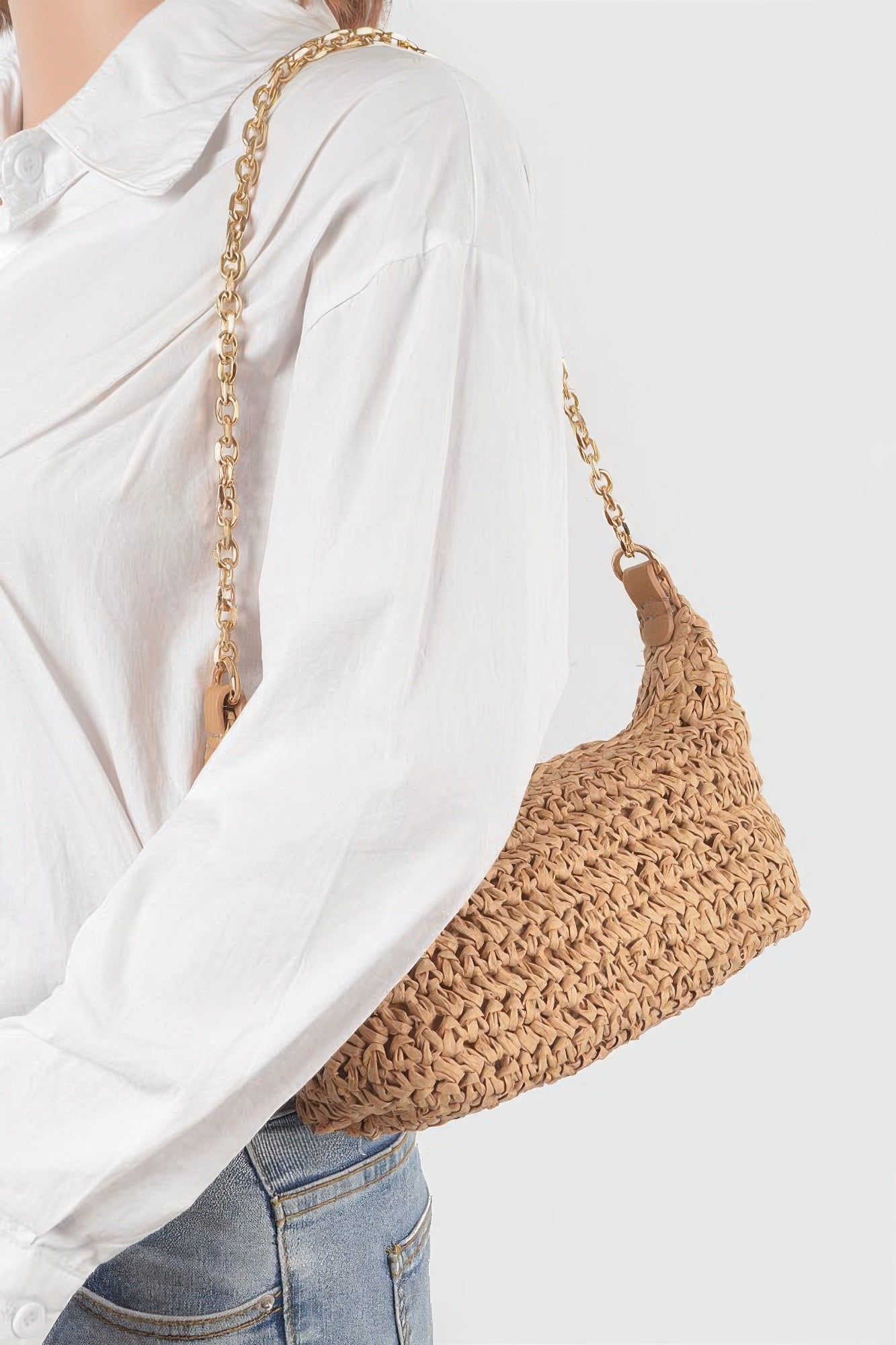 Khaki faux straw zip chain clutch, worn-style side view with gold chain strap