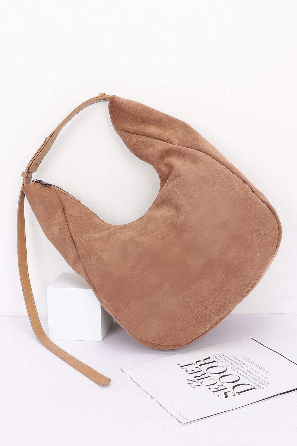Camel faux suede bindle bag, angled view, smooth suede-like finish