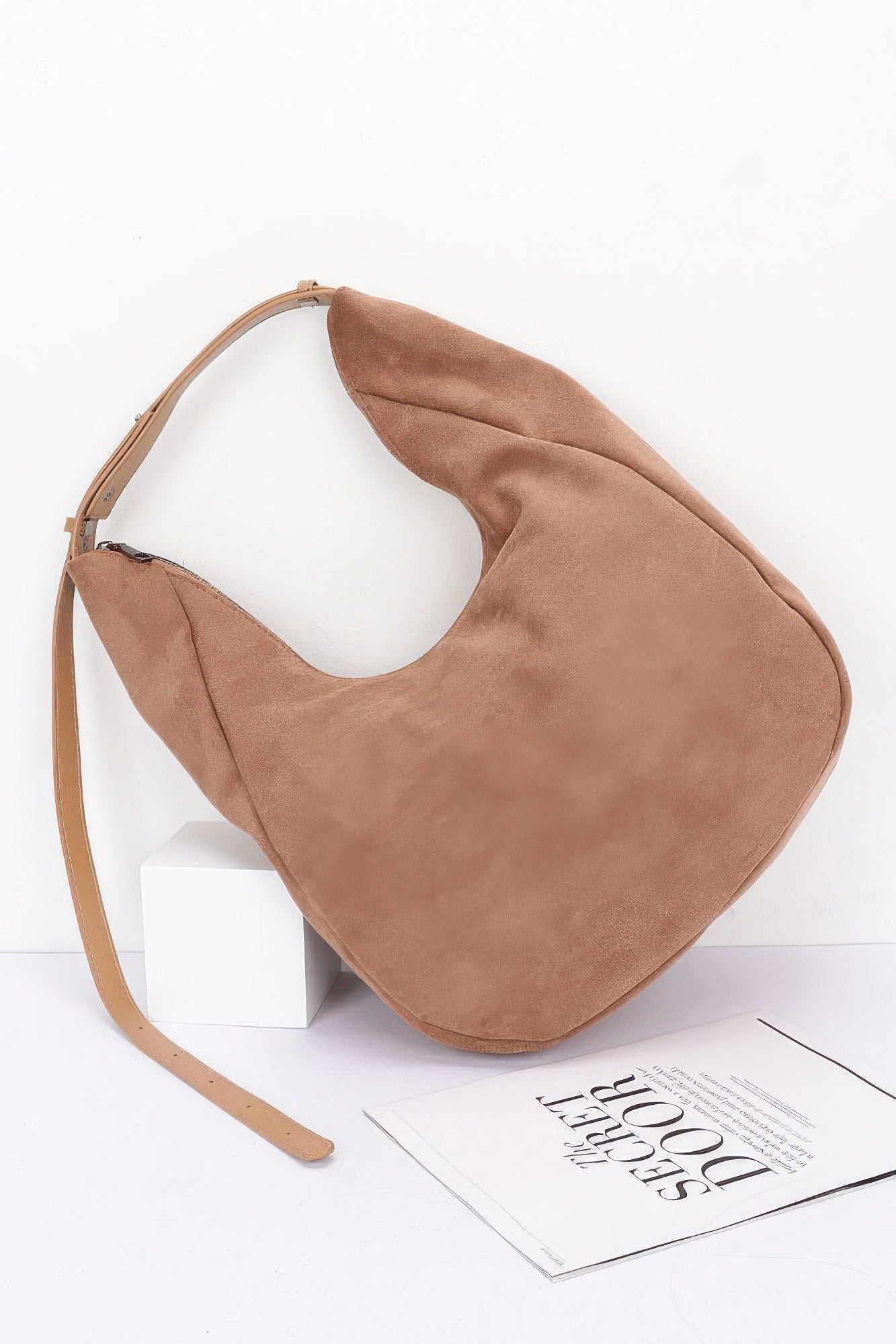 Camel faux suede bindle bag, angled view, smooth suede-like finish