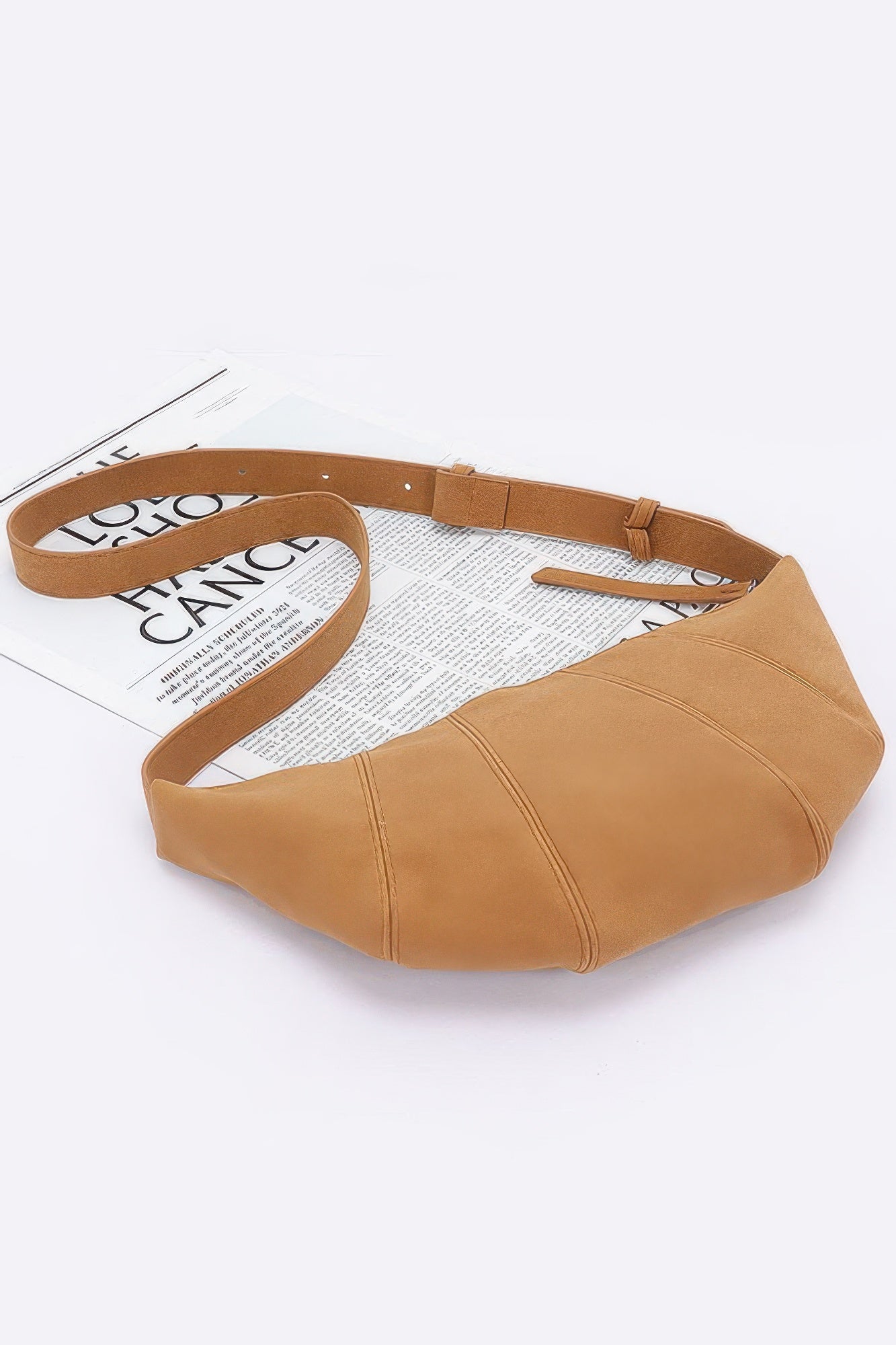 Camel faux suede croissant bag, laid flat view with strap and side seams