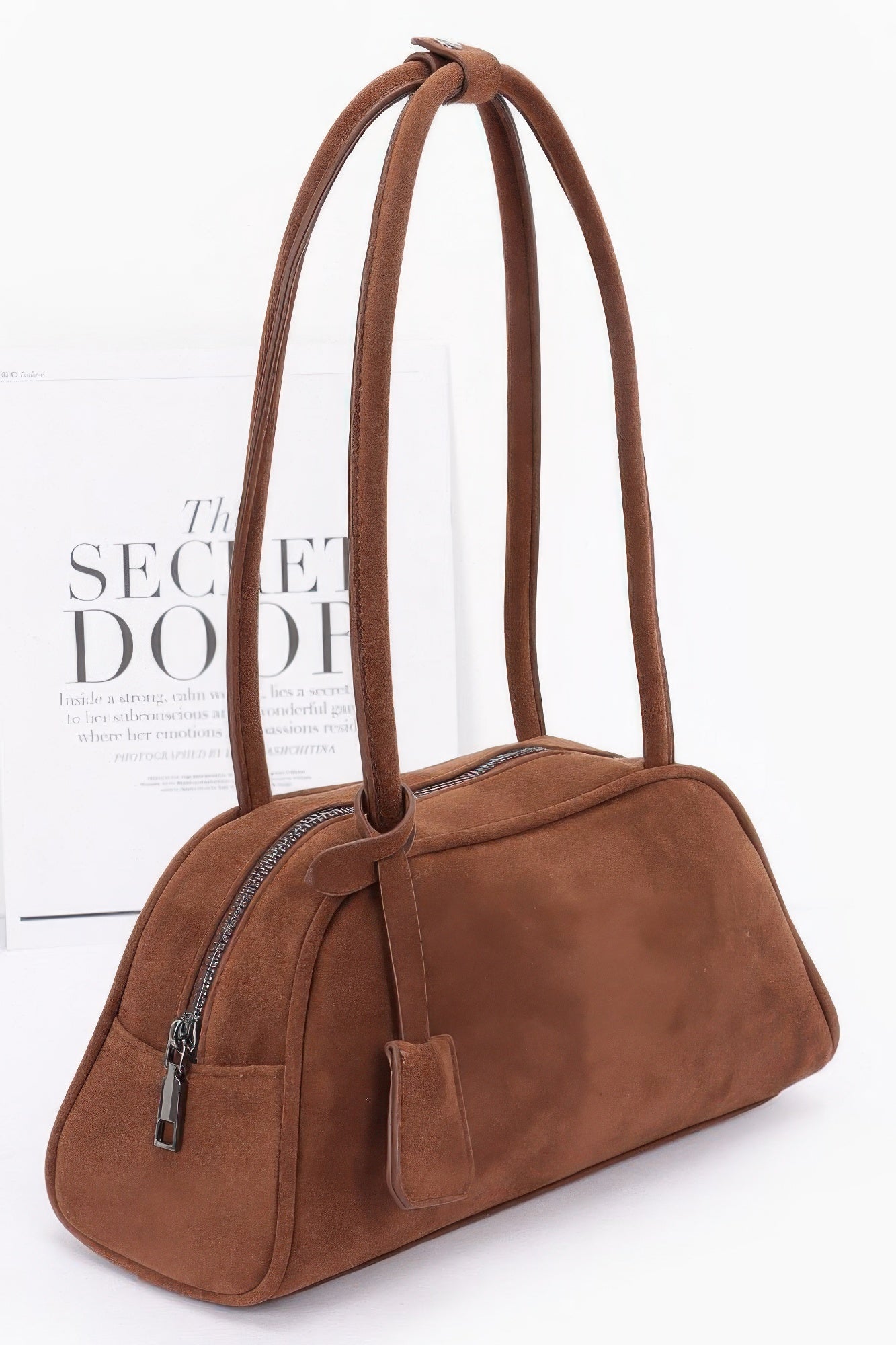 Brown faux suede sport bag side view with zipper pocket and strap
