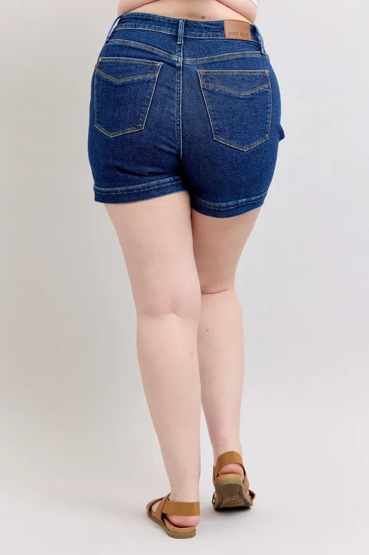 Dark blue denim shorts back close-up with belt loops and patch pockets