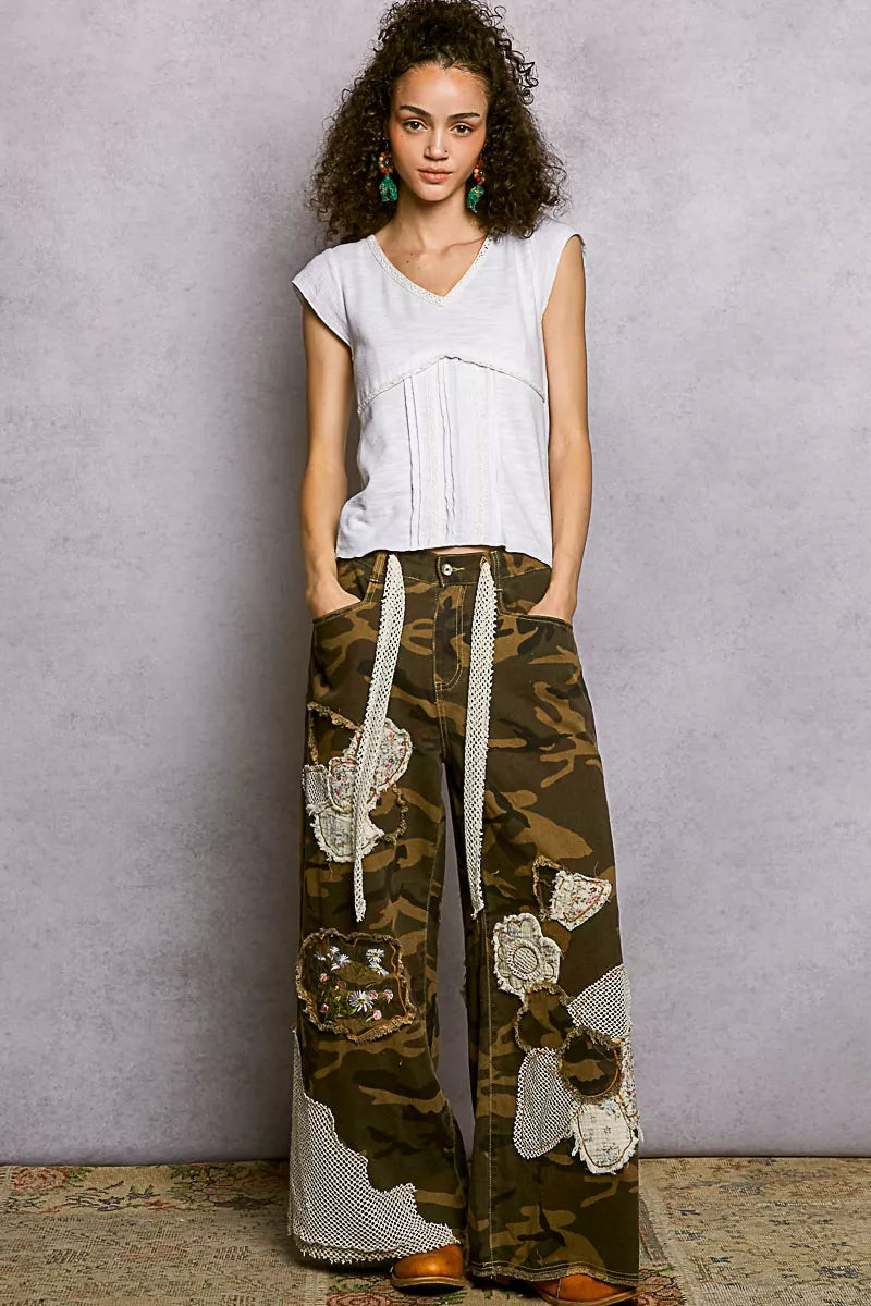 Off-white V-neck lightweight textured knit top with lace trim at neckline and hem
