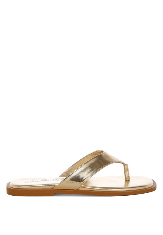 Gold square-toe flip-flop sandal on flat sole, side view