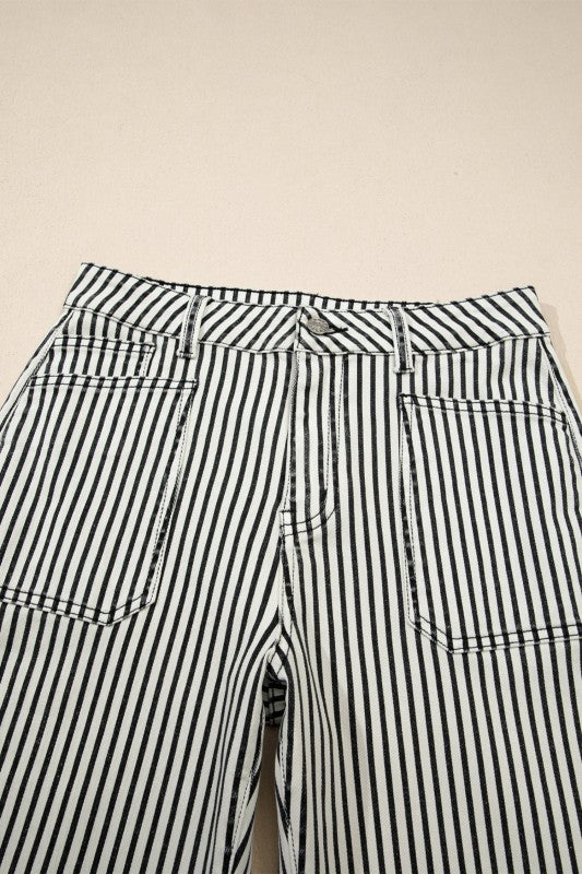 Close-up of high-waist striped jeans waistband with patch pockets and tie detail