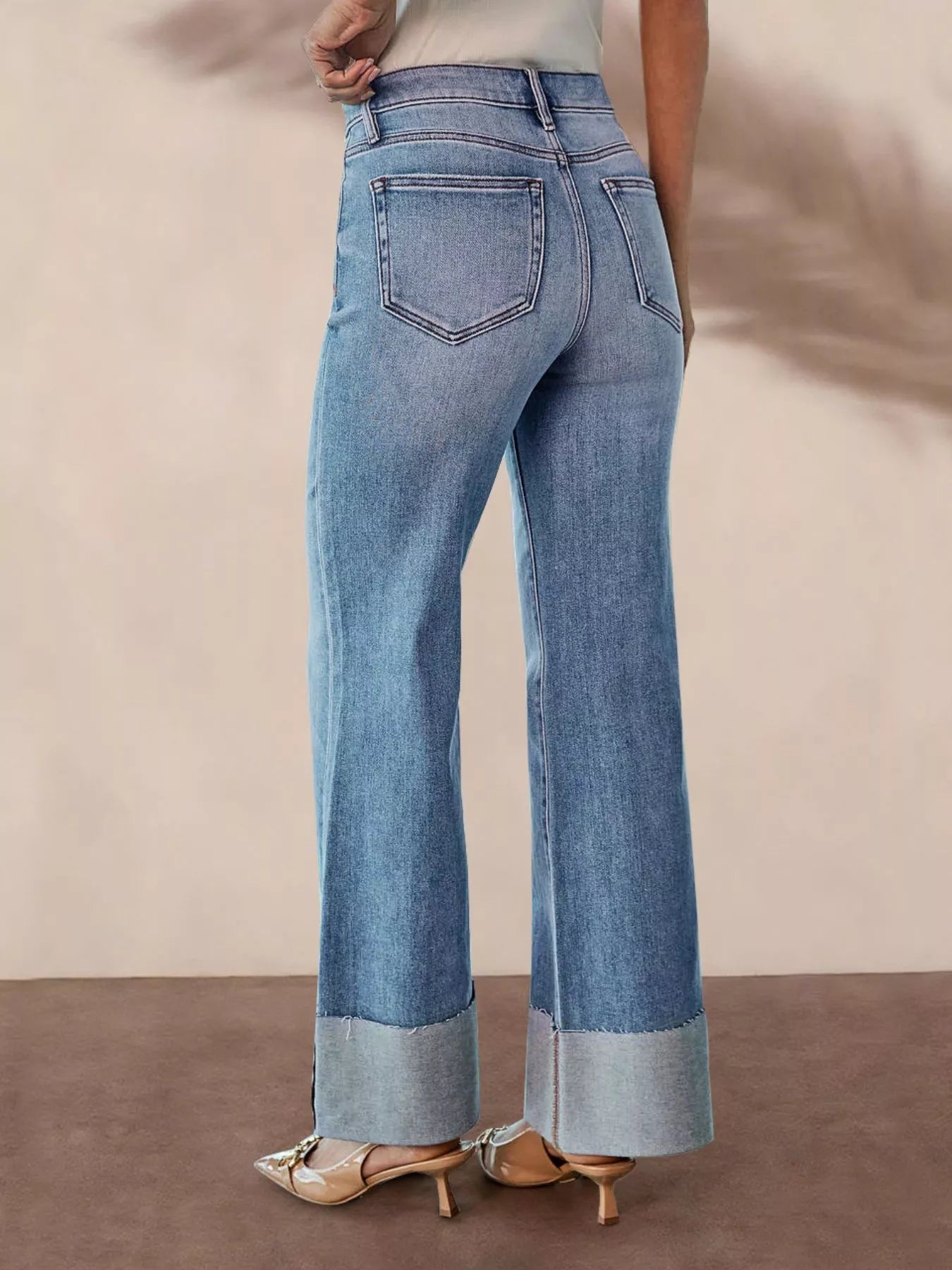 Blue distressed high-waisted wide-cuff flare jeans, back view with patch pockets