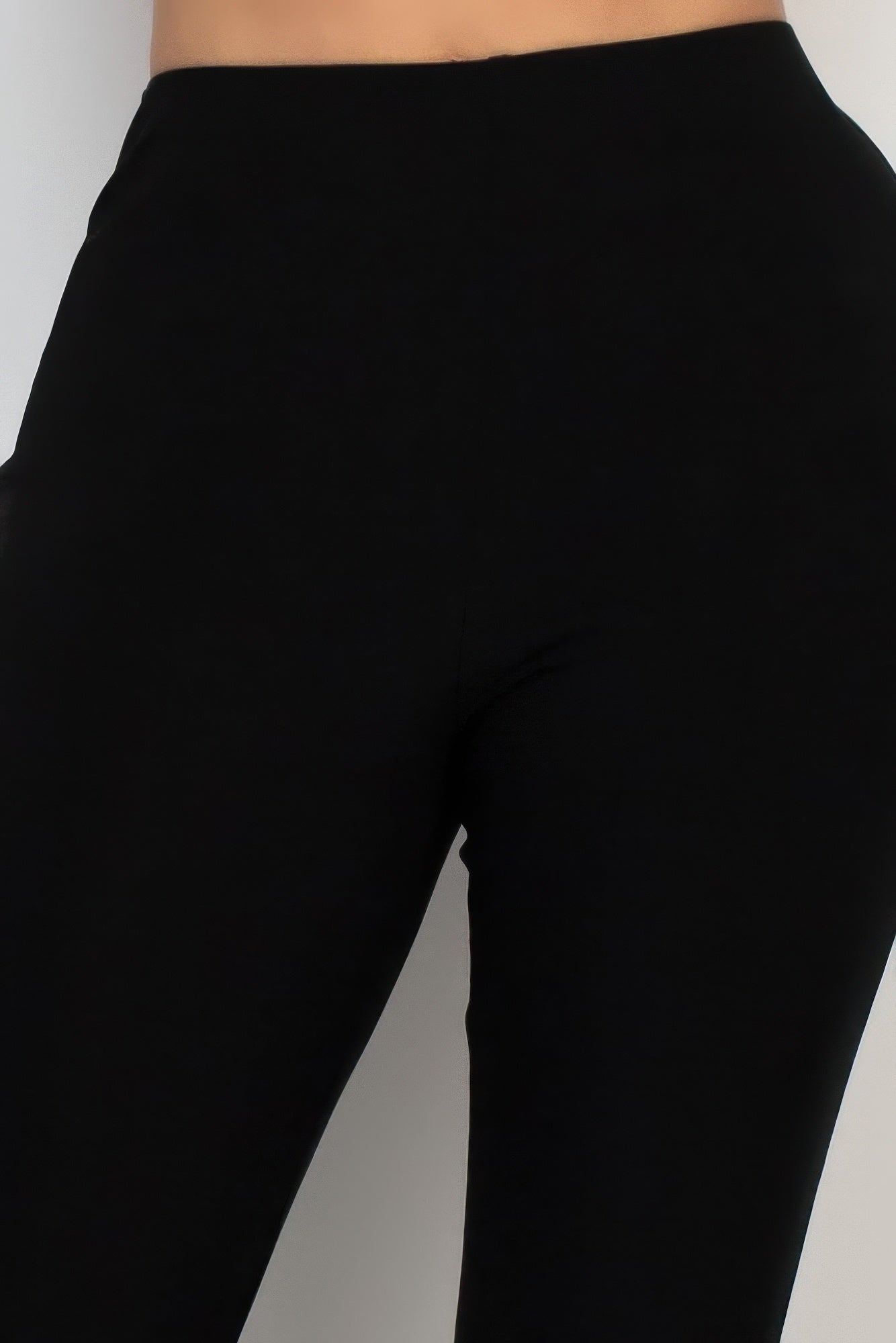 Black fit-and-flare pants close-up of high-waist seam and hip area