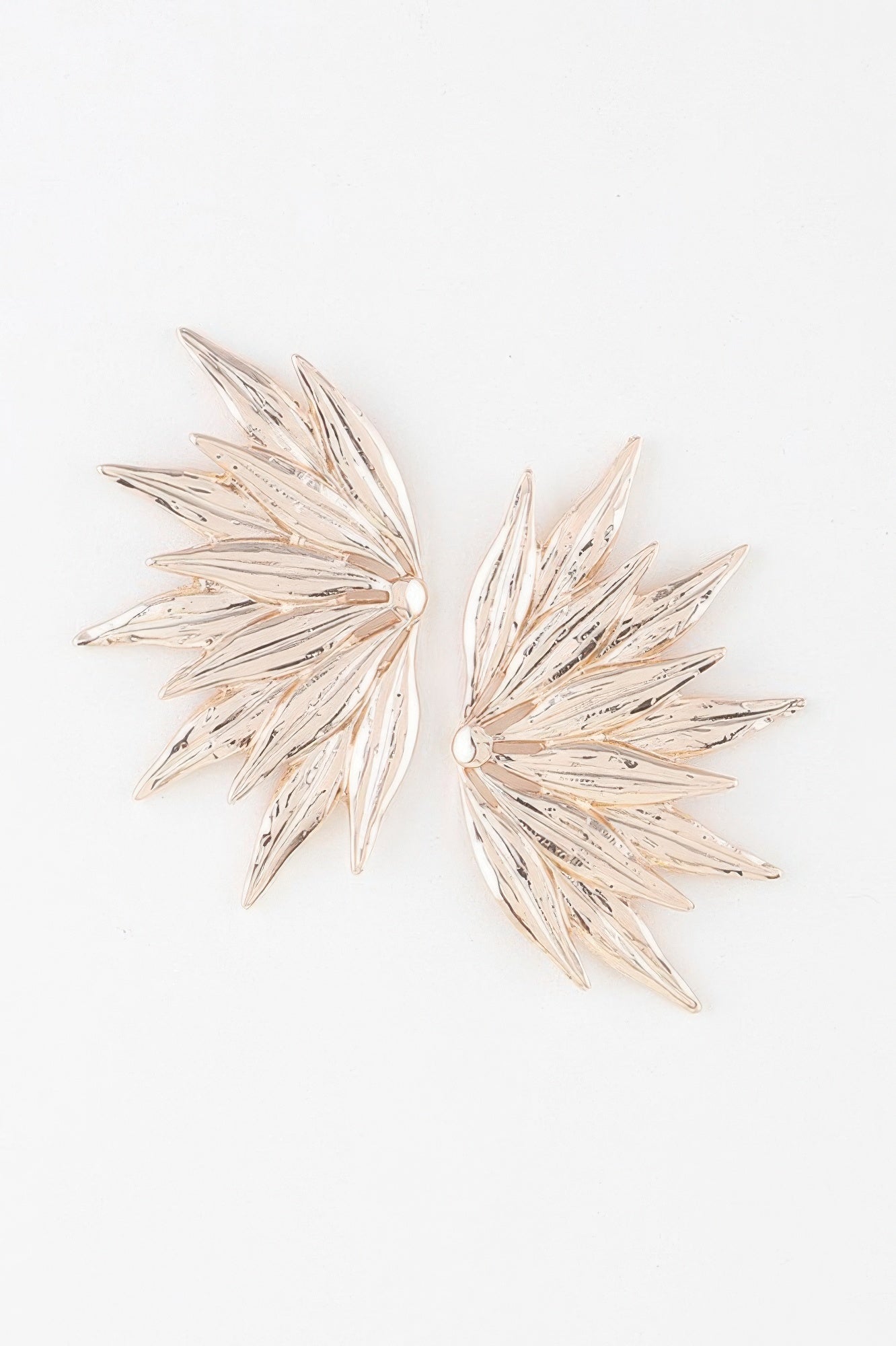 Flared petal wing earrings, gold-toned layered feather design, stud backs visible