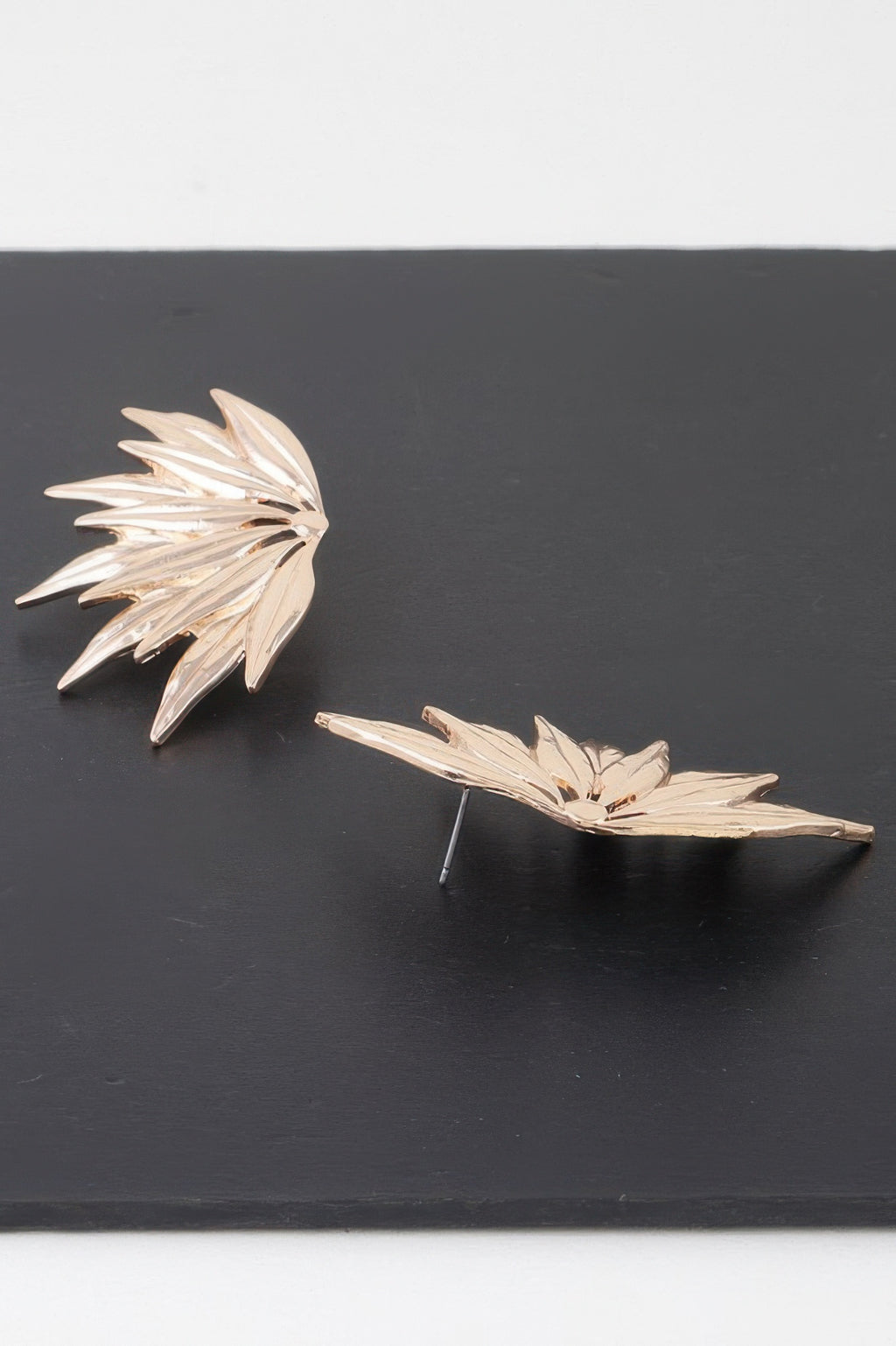 Flared petal wing earrings in gold tone, side profile with straight stud pins