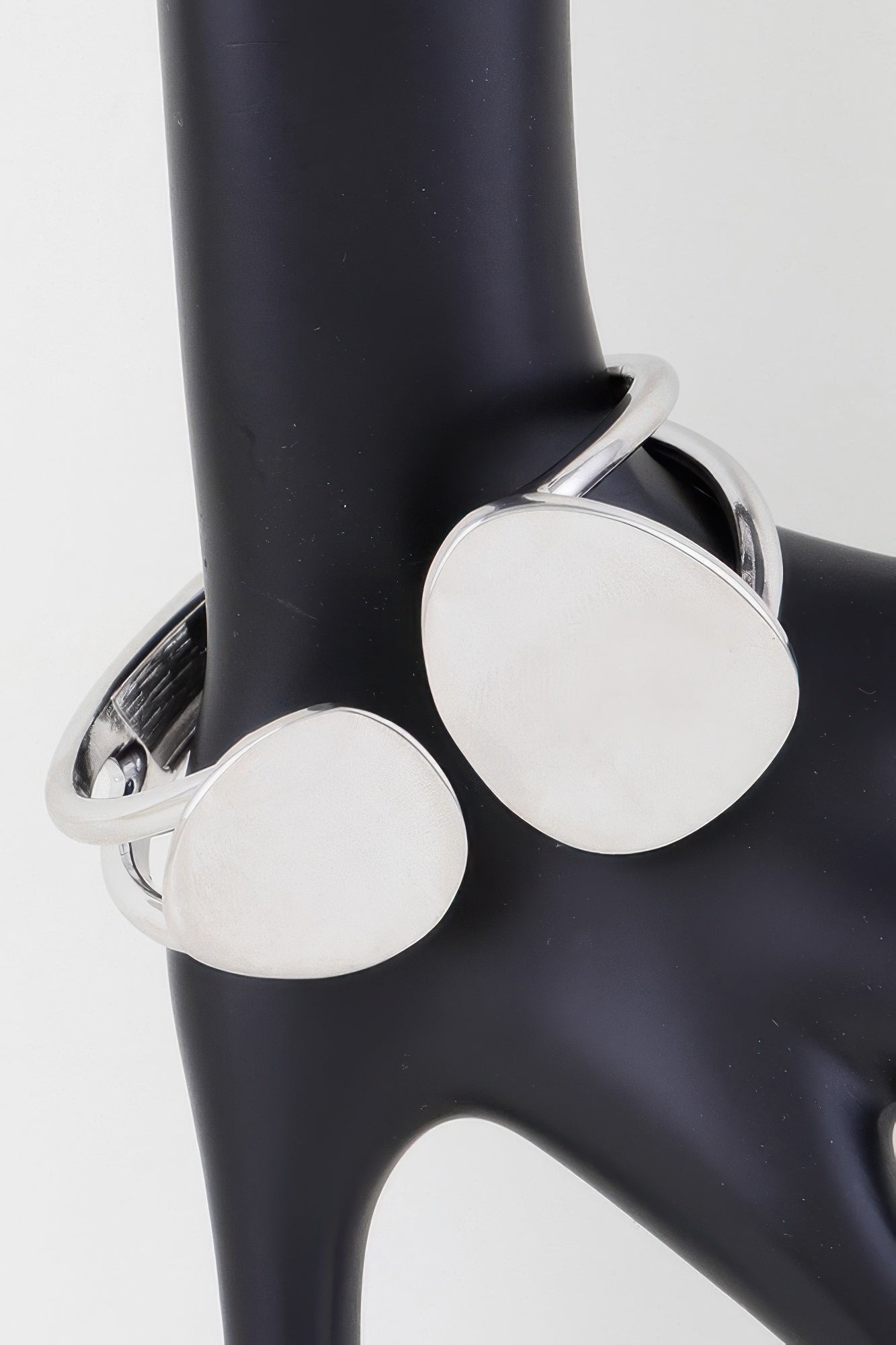 Silver wrap bracelet with two round flat discs on cuff