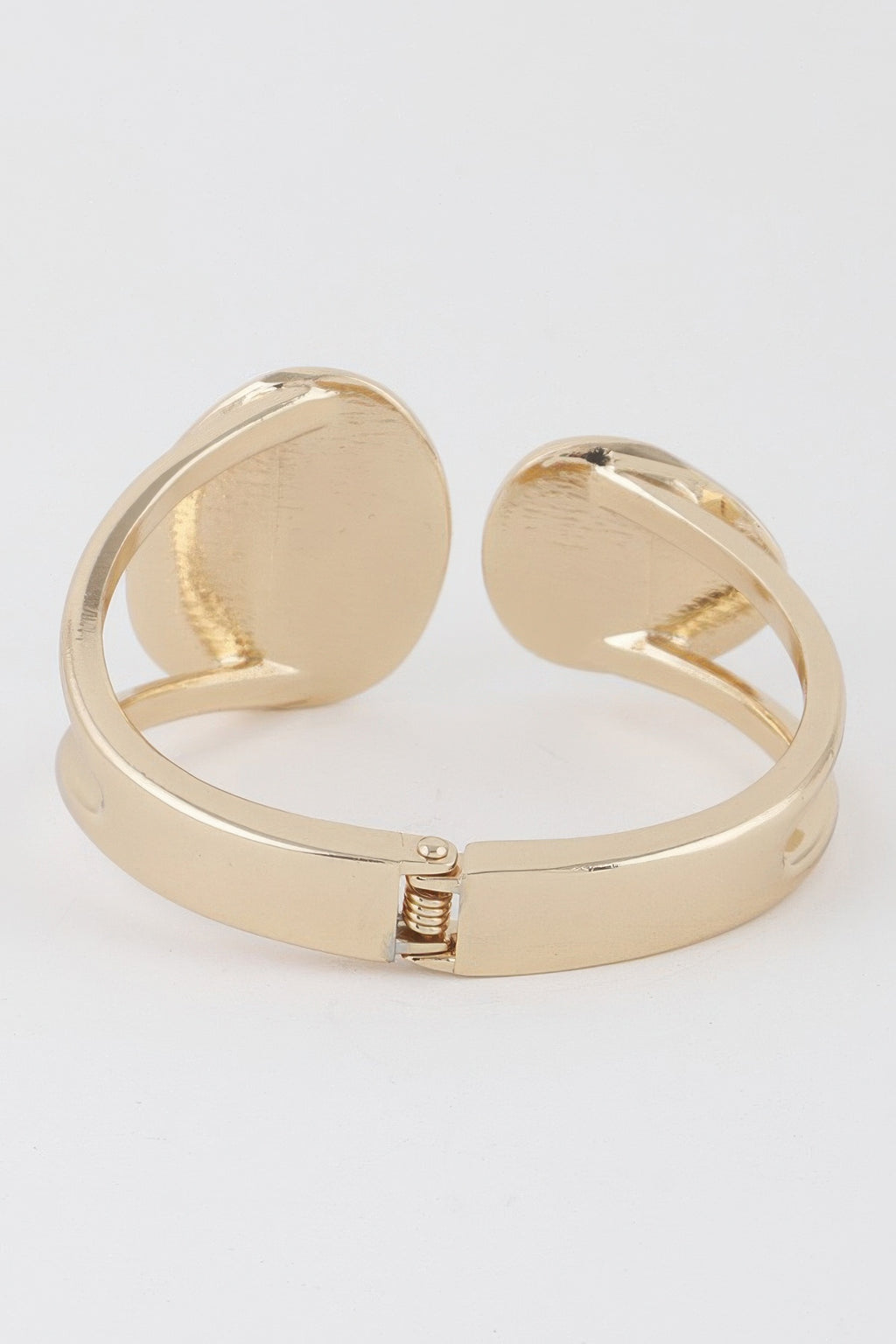 Gold wrap bracelet with two round flat discs and visible spring closure