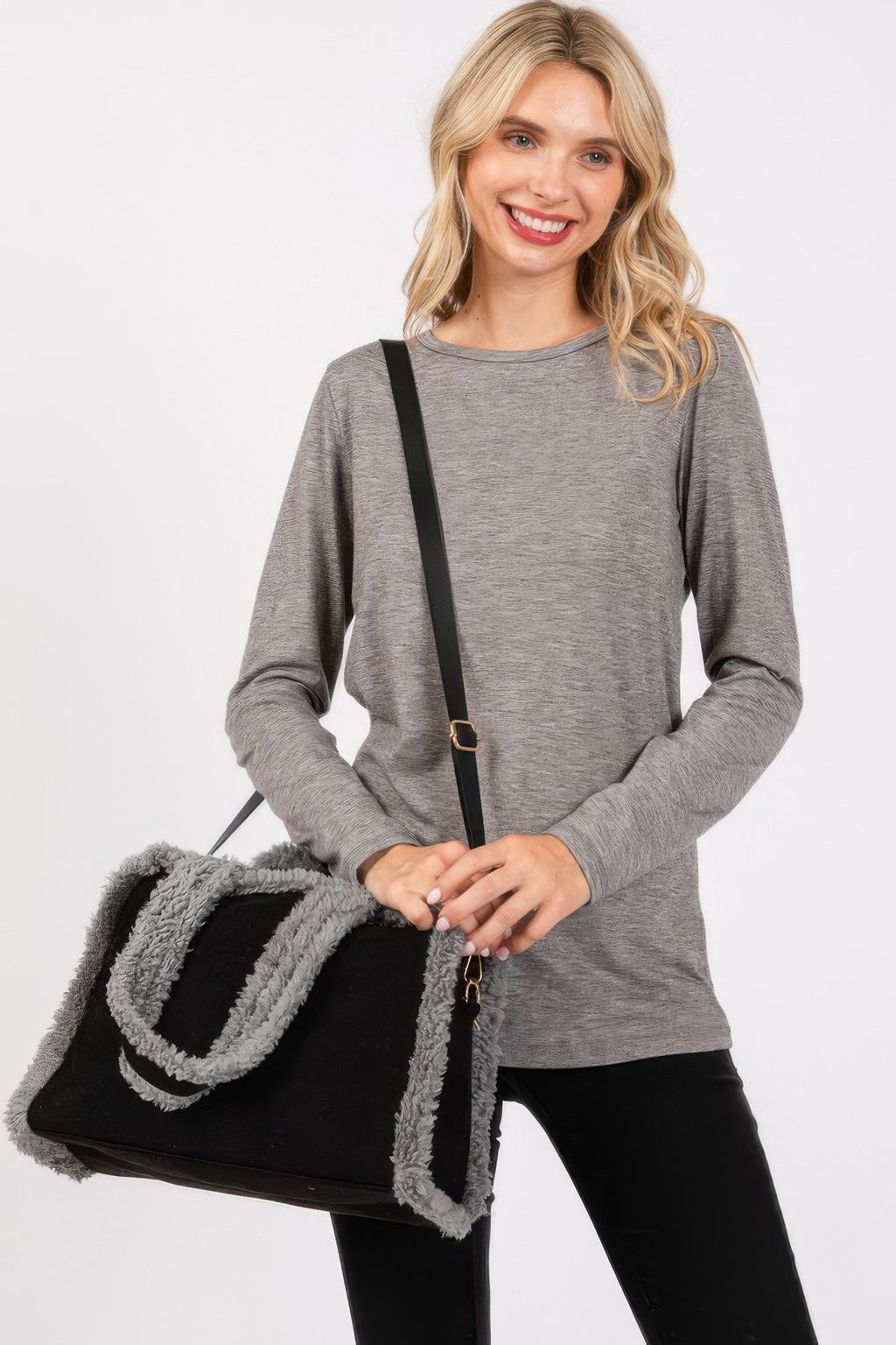 Solid tote and crossbody bag in black with gray fleece trim and adjustable strap