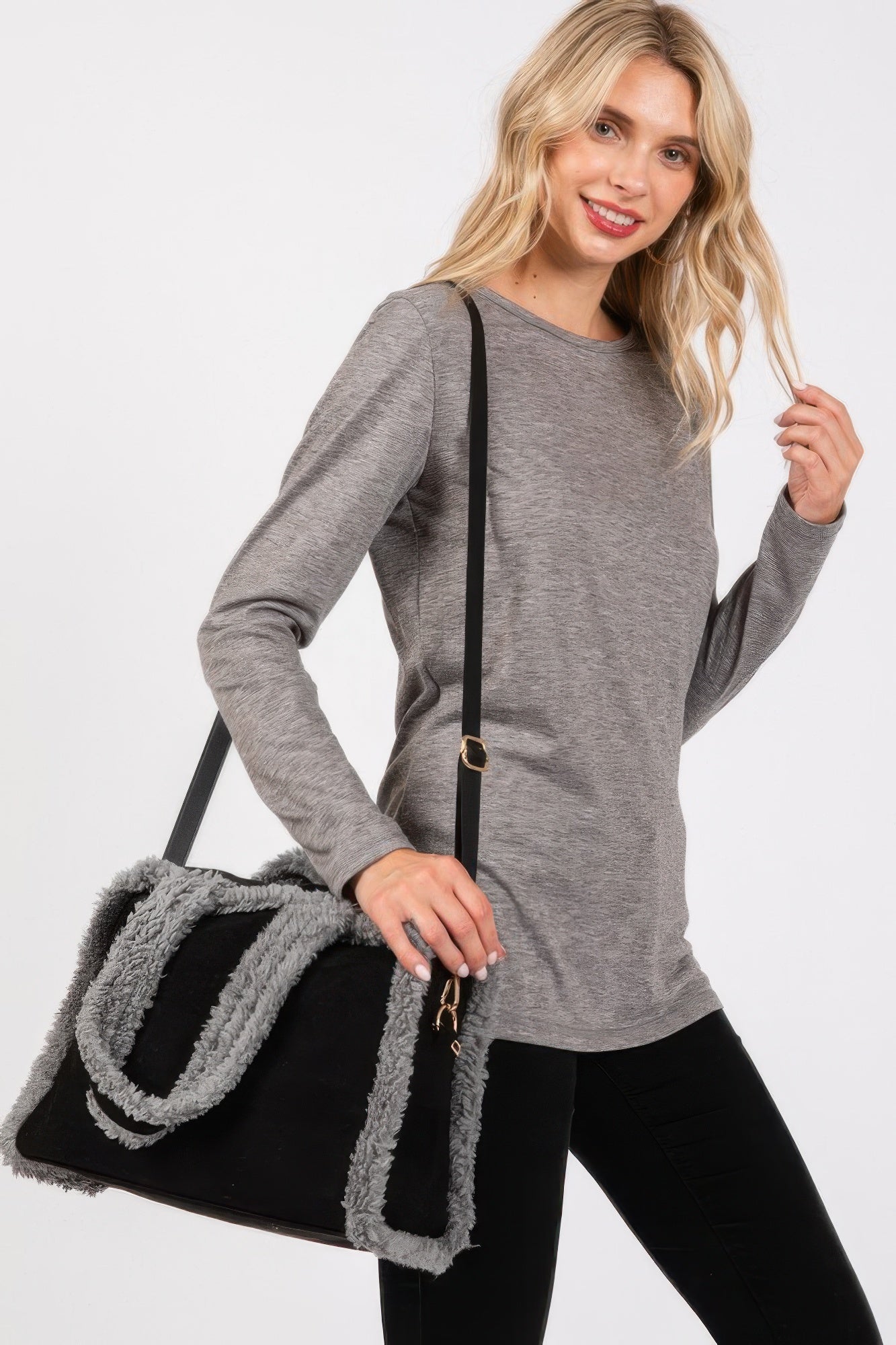 Black fleece-trim tote bag with long strap and gold-tone hardware detail