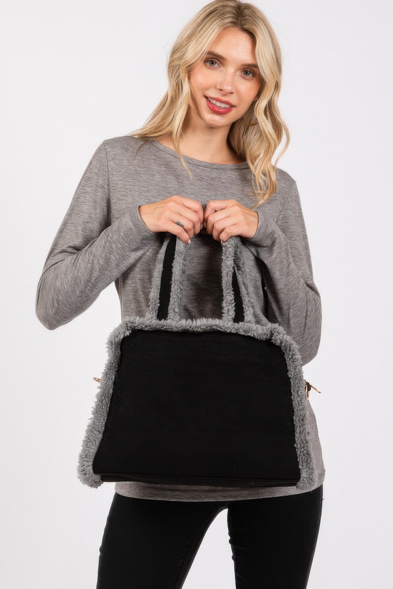 Black tote bag with gray fuzzy trim, top handles, and side grommets