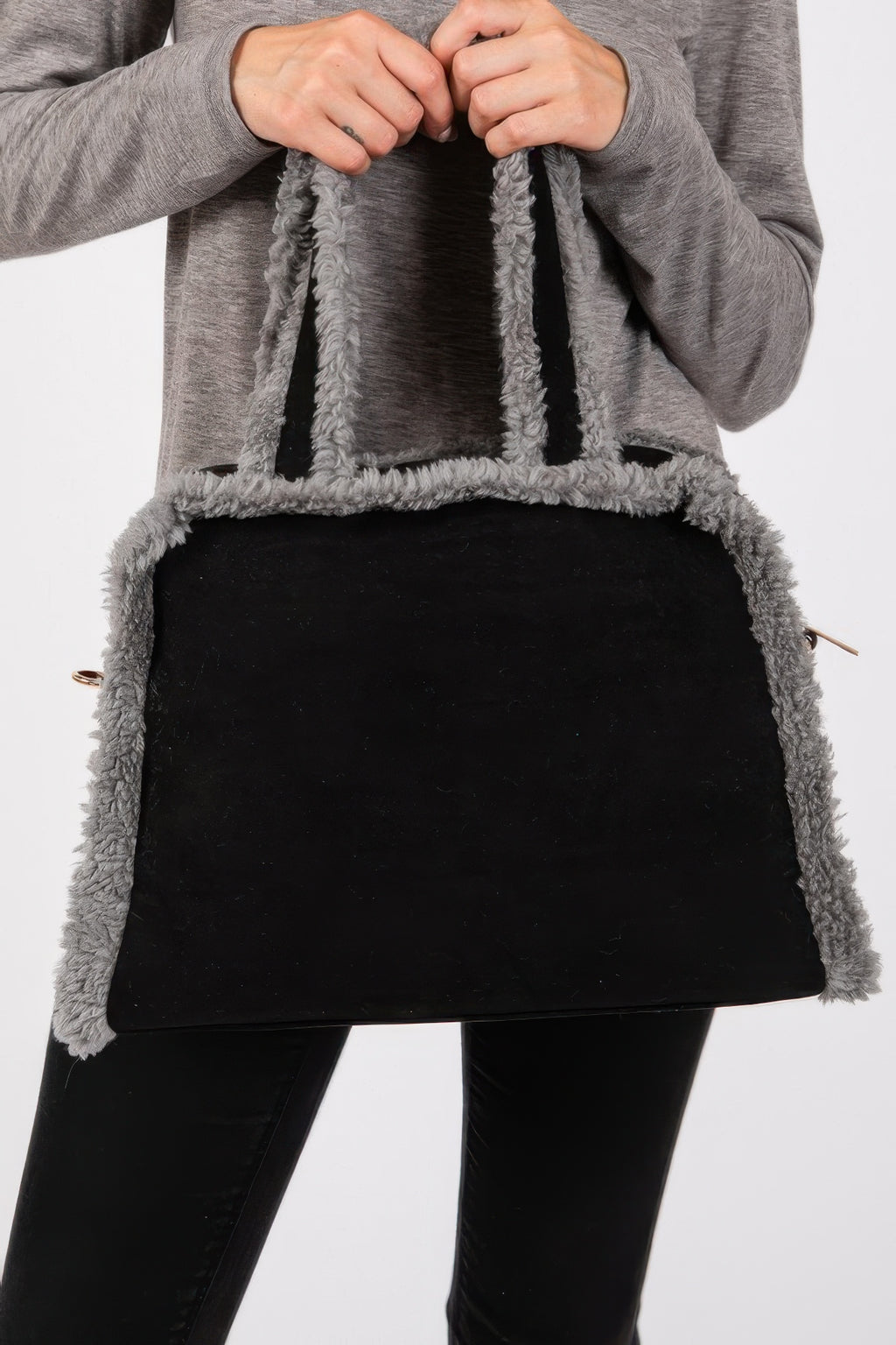 Close-up: black bag with gray fleece border and visible zipper pull