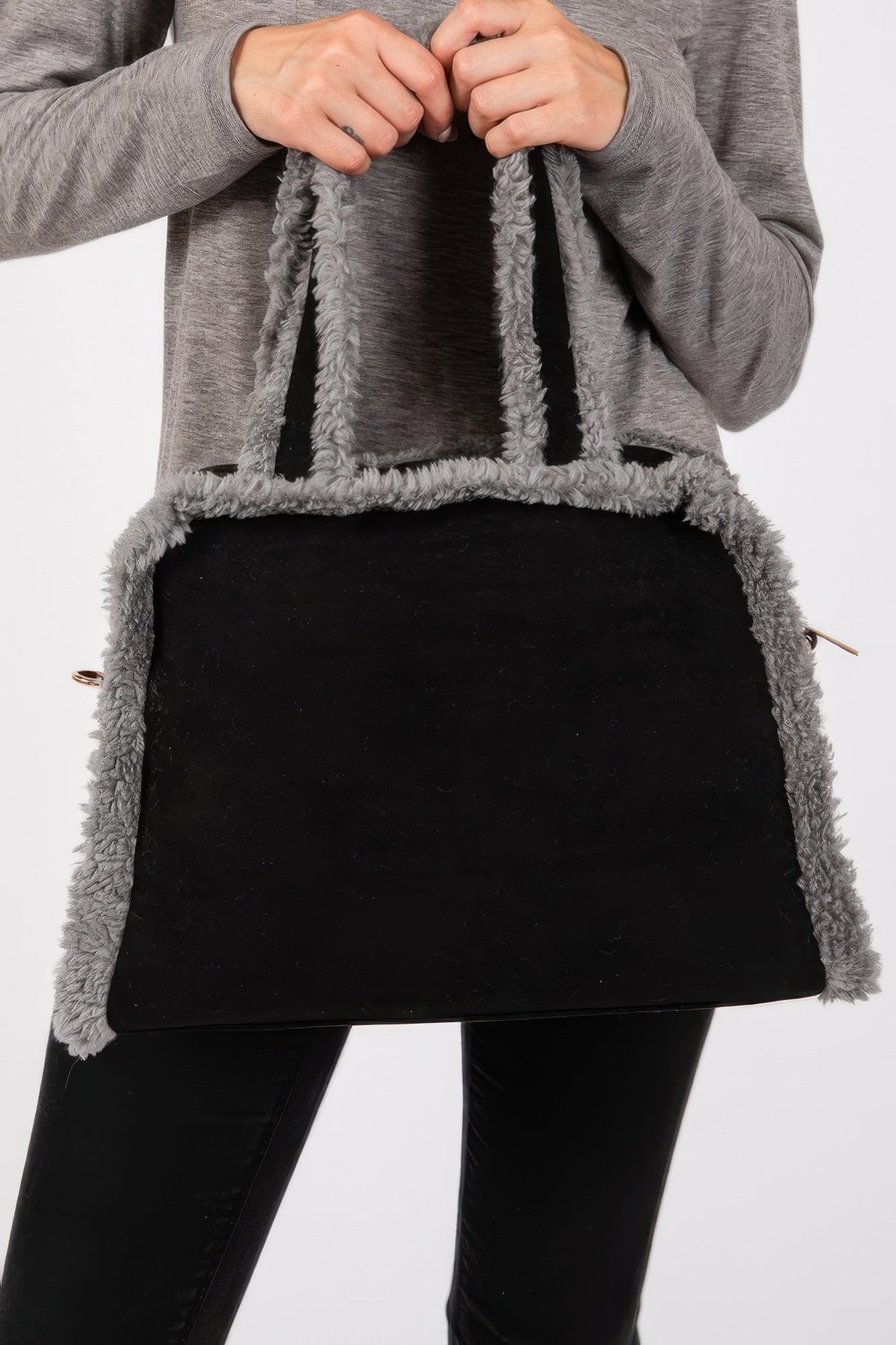 Close-up: black bag with gray fleece border and visible zipper pull