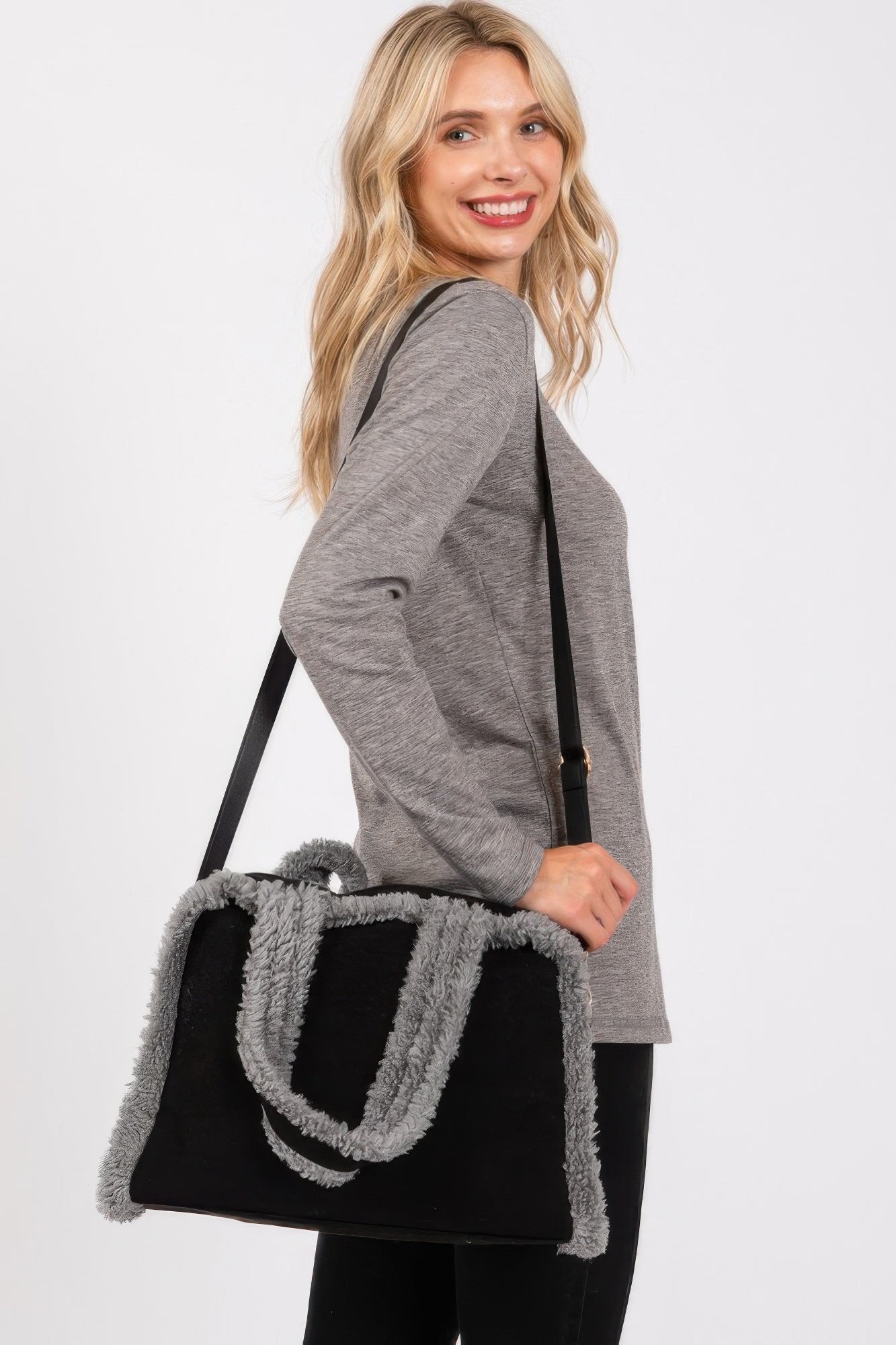 Black tote bag with gray fleece trim and striped panel design on front