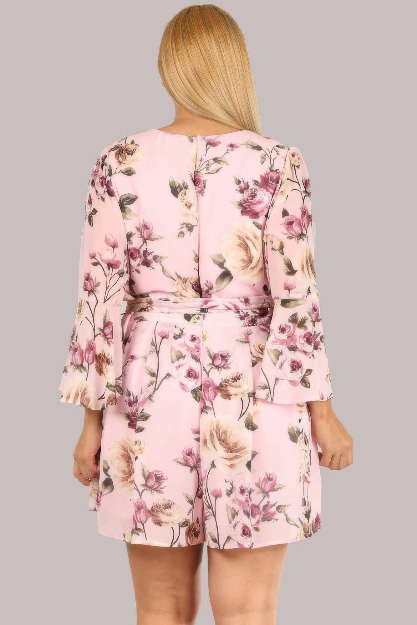 Back view: floral chiffon romper with tie waist and pink rose print, 3/4 sleeves