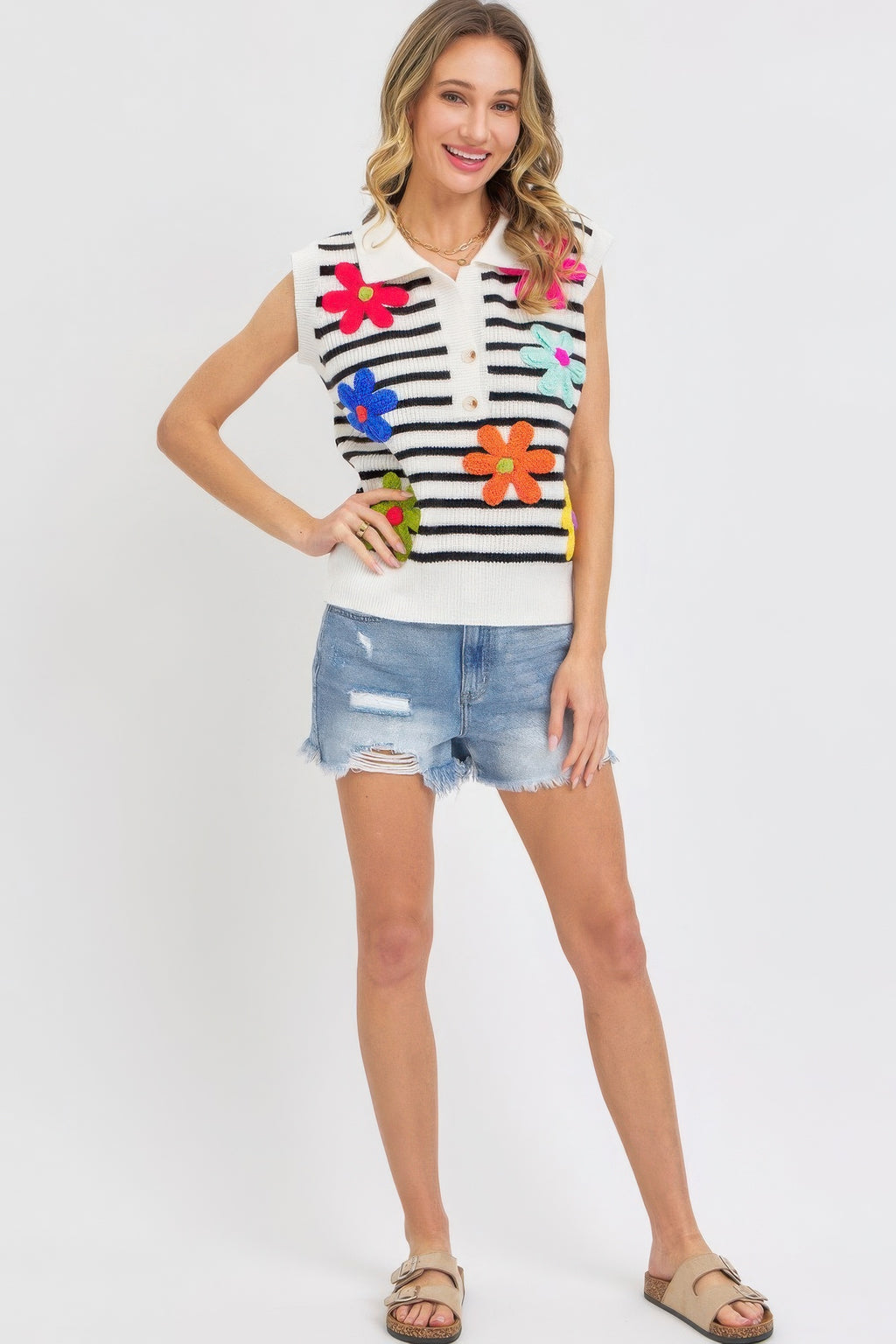 Ivory-and-black striped knit vest-style top with colorful flower embroidery