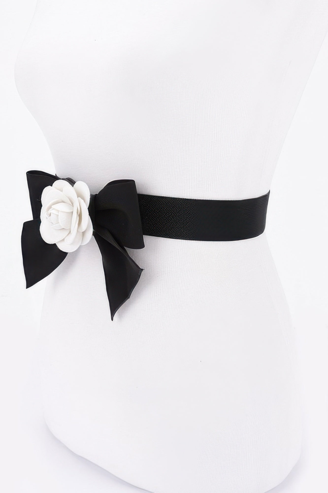 Black elastic ribbon belt with white flower rosette and bow on one side