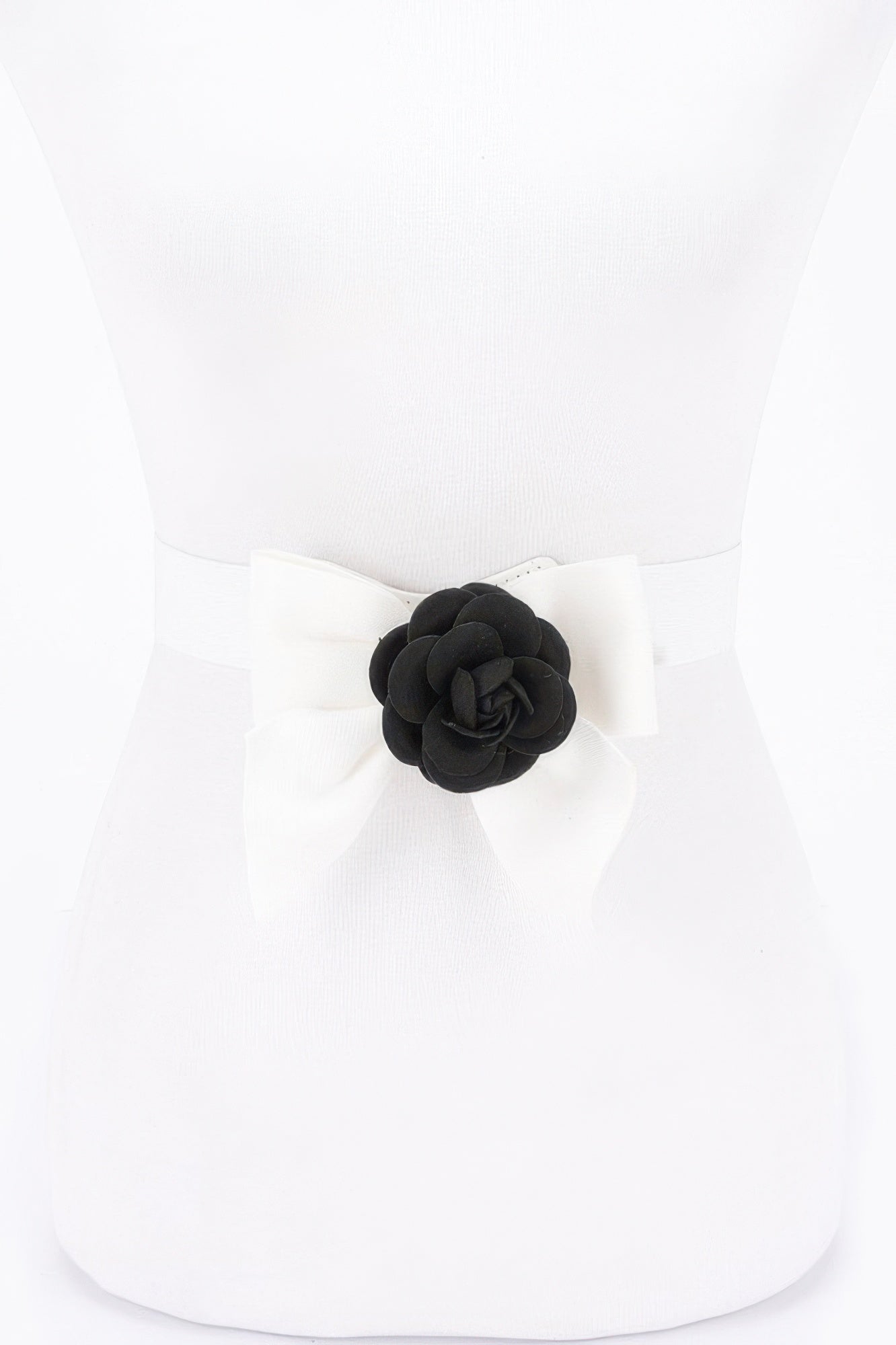 Ivory elastic ribbon belt with black flower rosette centerpiece