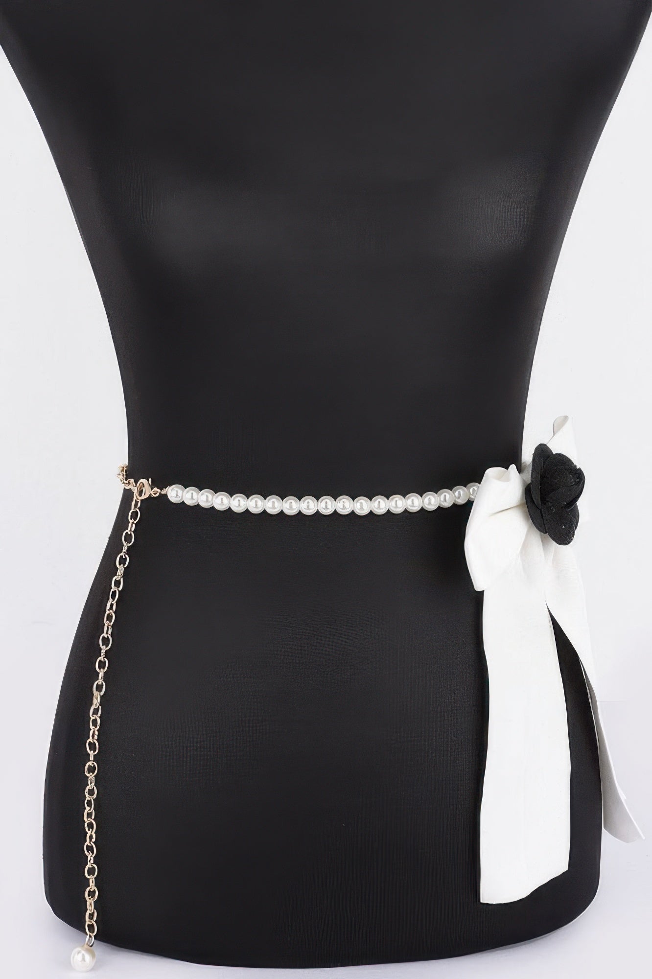 Faux pearl belt with gold chain drop and black-and-white ribbon flower on side