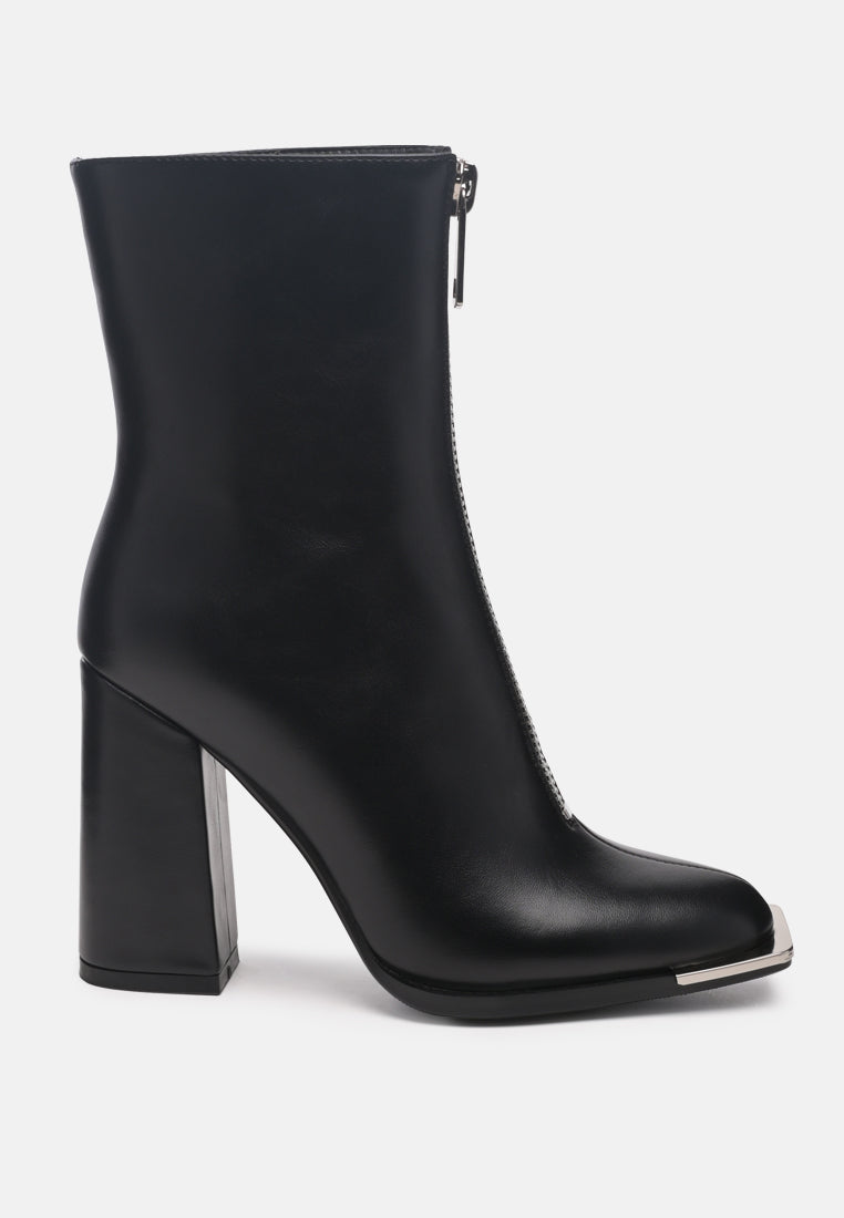 Black ankle boot with a block heel on a white background