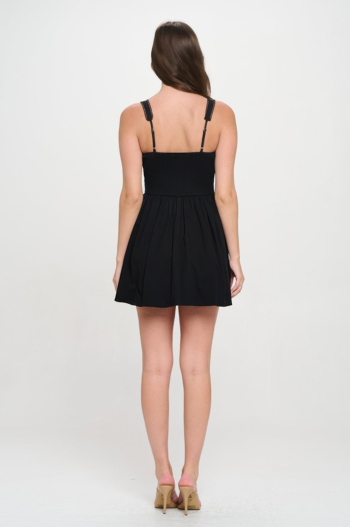 Rückansicht: Schwarzes Bustierkleid mit schmalen Trägern und gerafftem Faltenrock